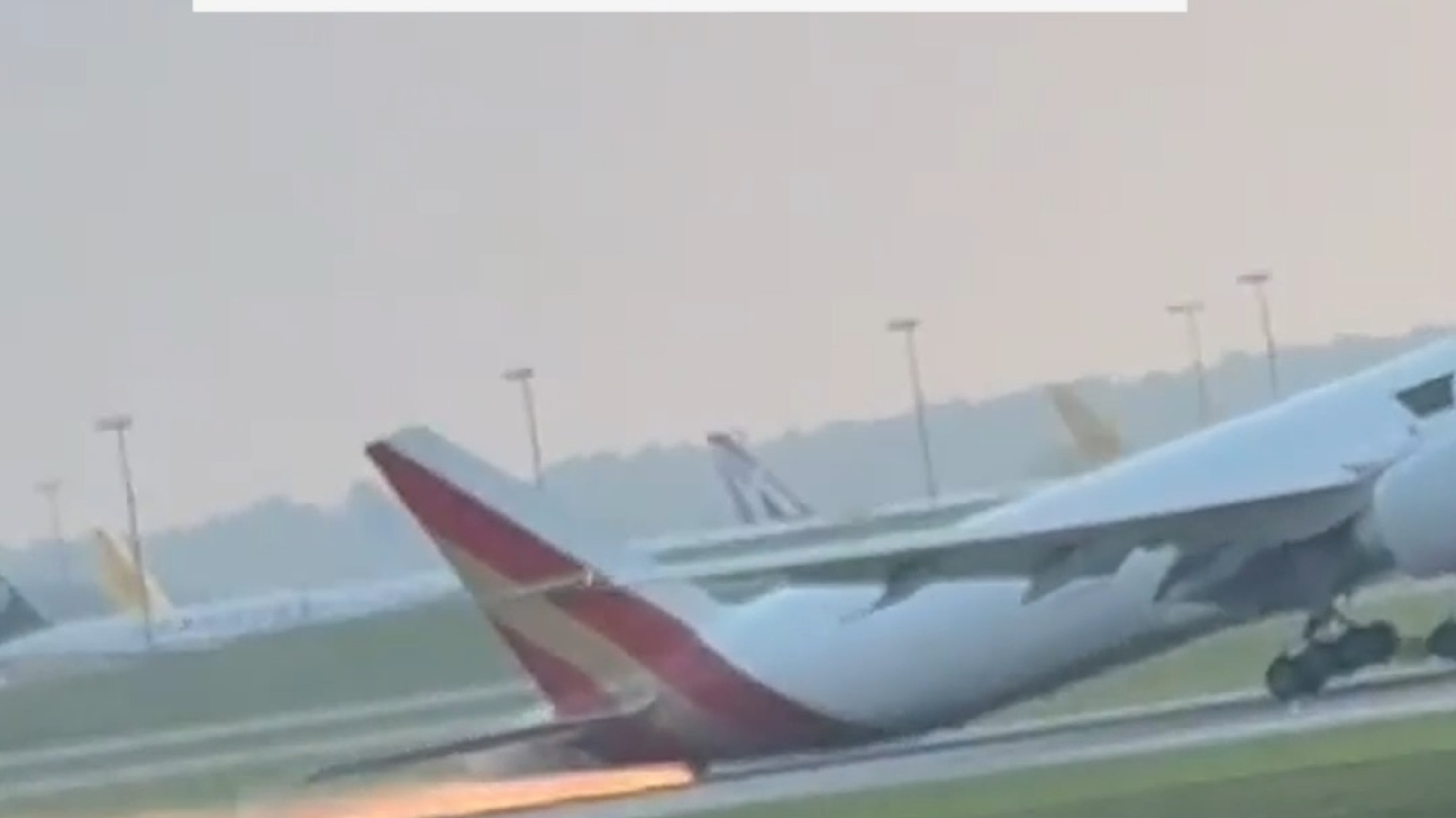 Sparks fly from tail of cargo plane during attempted landing
