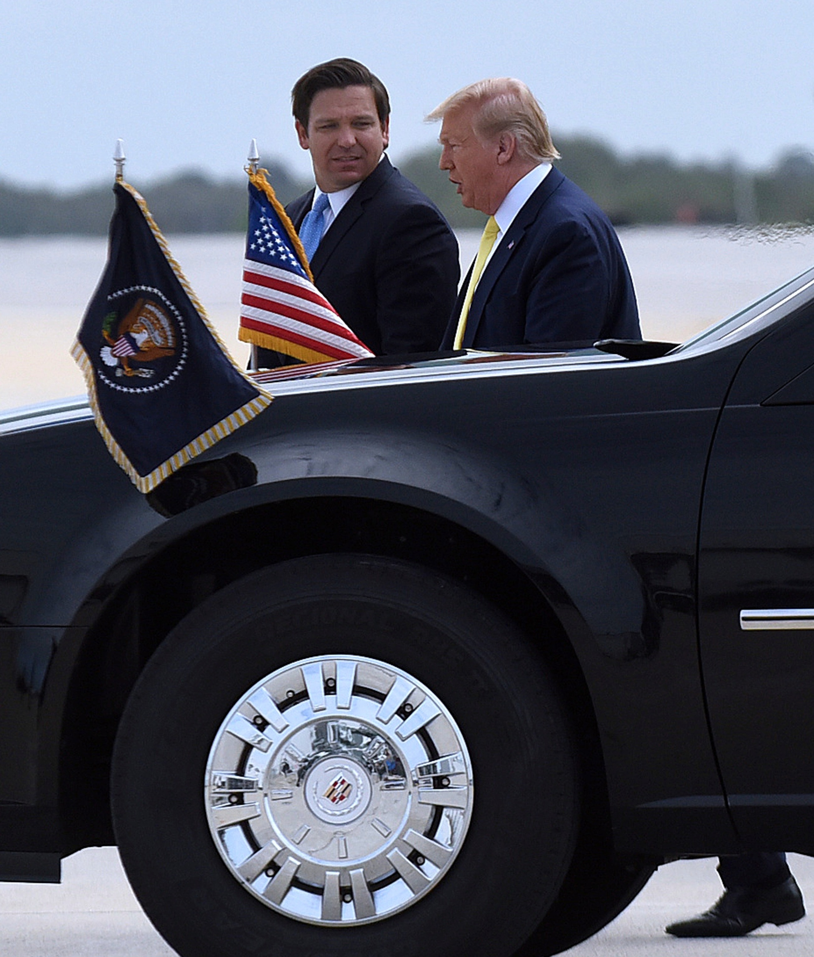 PHOTO: President Donald Trump meets Florida Gov. Ron DeSantis as he arrives on Air Force One at Orlando Sanford International Airport.