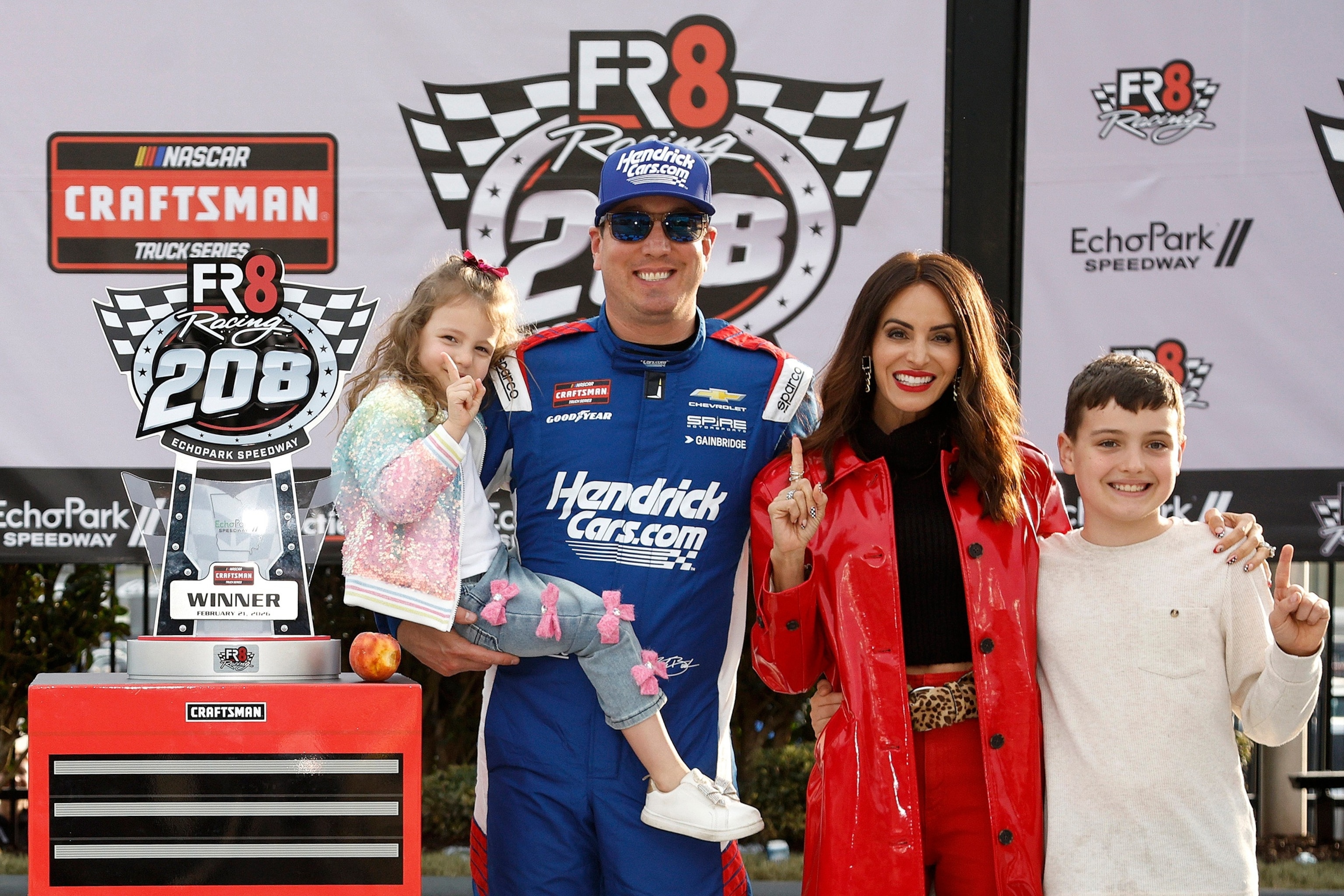 PHOTO: Kyle Busch celebrates with daughter, Lennix Busch, son, Brexton Busch, and wife, Samantha Busch, in victory lane after winning the NASCAR Craftsman Truck Series Fr8 Racing 208 at Echo Park Speedway on Feb. 21, 2026, in Hampton, Georgia.