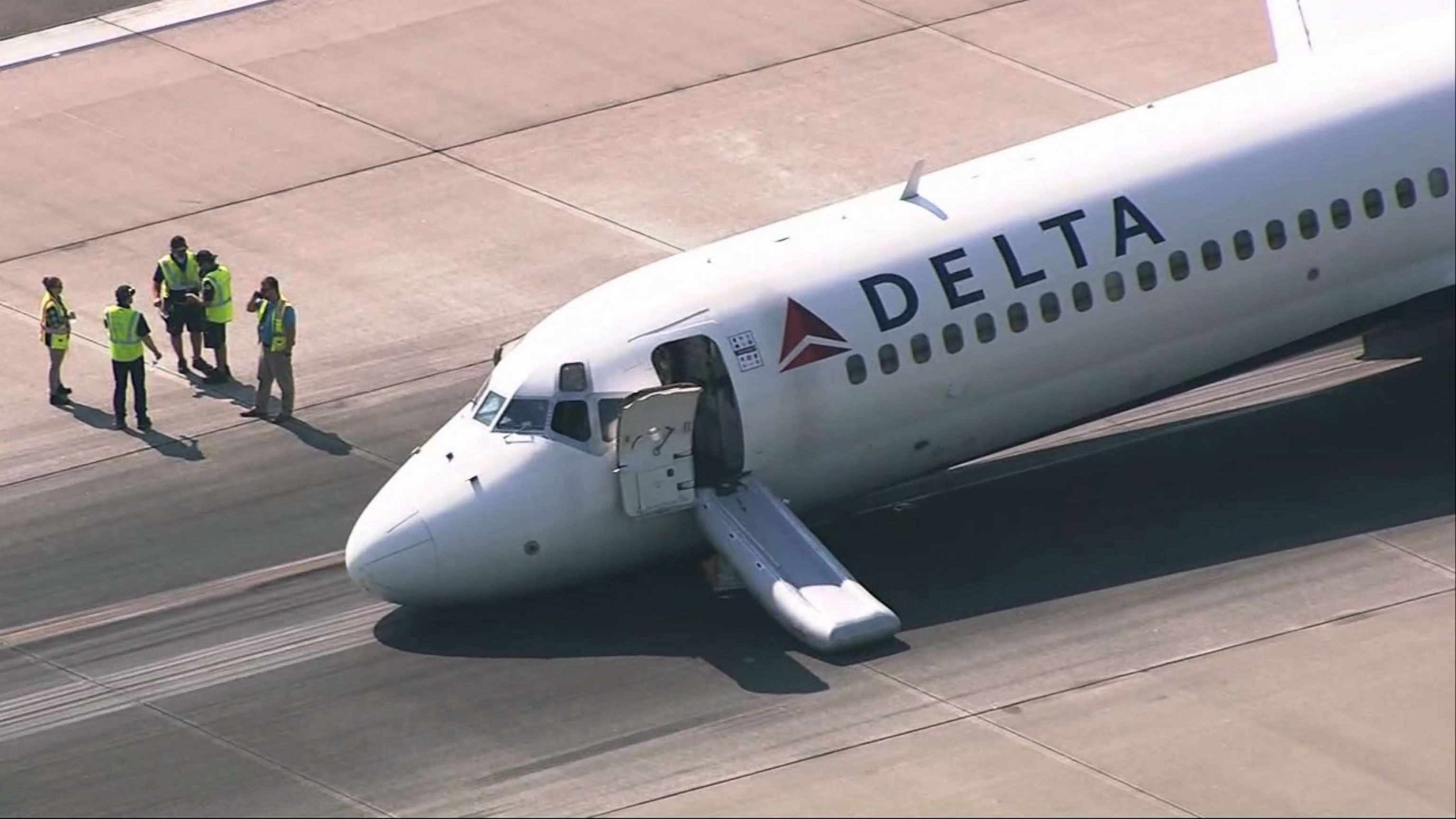 PHOTO: A plane that landed at Charlotte Douglas International Airport in N.C. without its landing gear extended, sits on the runway, June 28, 2023.