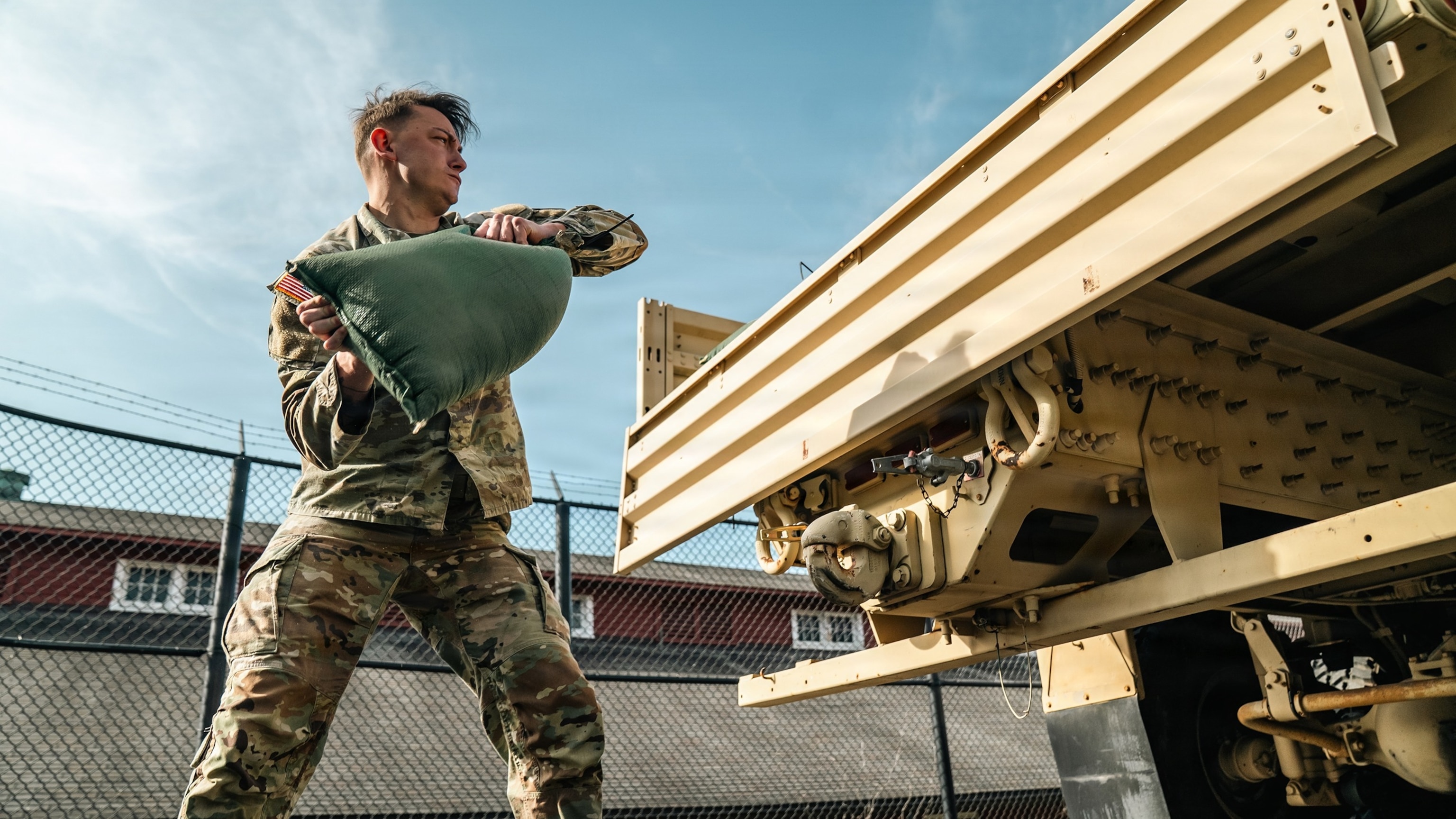 PHOTO: U.S. Army Sgt. Christopher Smith assigned to 1st Battalion, 3d U.S. Infantry Regiment (The Old Guard) lifts a 40-lbs sandbag during the new Combat Field Test (CFT), at Joint Base Myer-Henderson Hall, Va. 