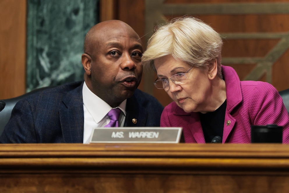 PHOTO: In this Feb. 26, 2026, file photo, Chairman of the Senate Committee on Banking, Housing, and Urban Affairs Sen. Tim Scott speaks with Ranking Member Sen. Elizabeth Warren in Washington, D.C.