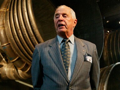 Apollo 8 Lunar Module Pilot Gen. William Anders, speaks to reporters in front of the Saturn 5 Aft End, the F-1 rocket engines of the first stage of the Apollo 11/Saturn 5 launch vehicle July 20, 2004, in Washington.