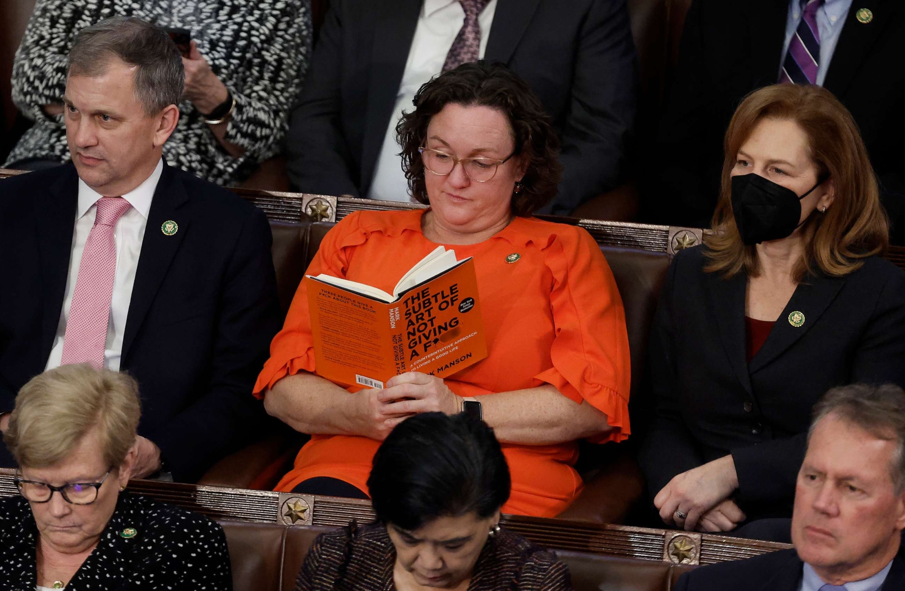 PHOTO: Rep. Katie Porter reads a book with a pointed title in the House Chamber during the fourth day of elections for Speaker of the House at the U.S. Capitol on Jan. 06, 2023 in Washington.