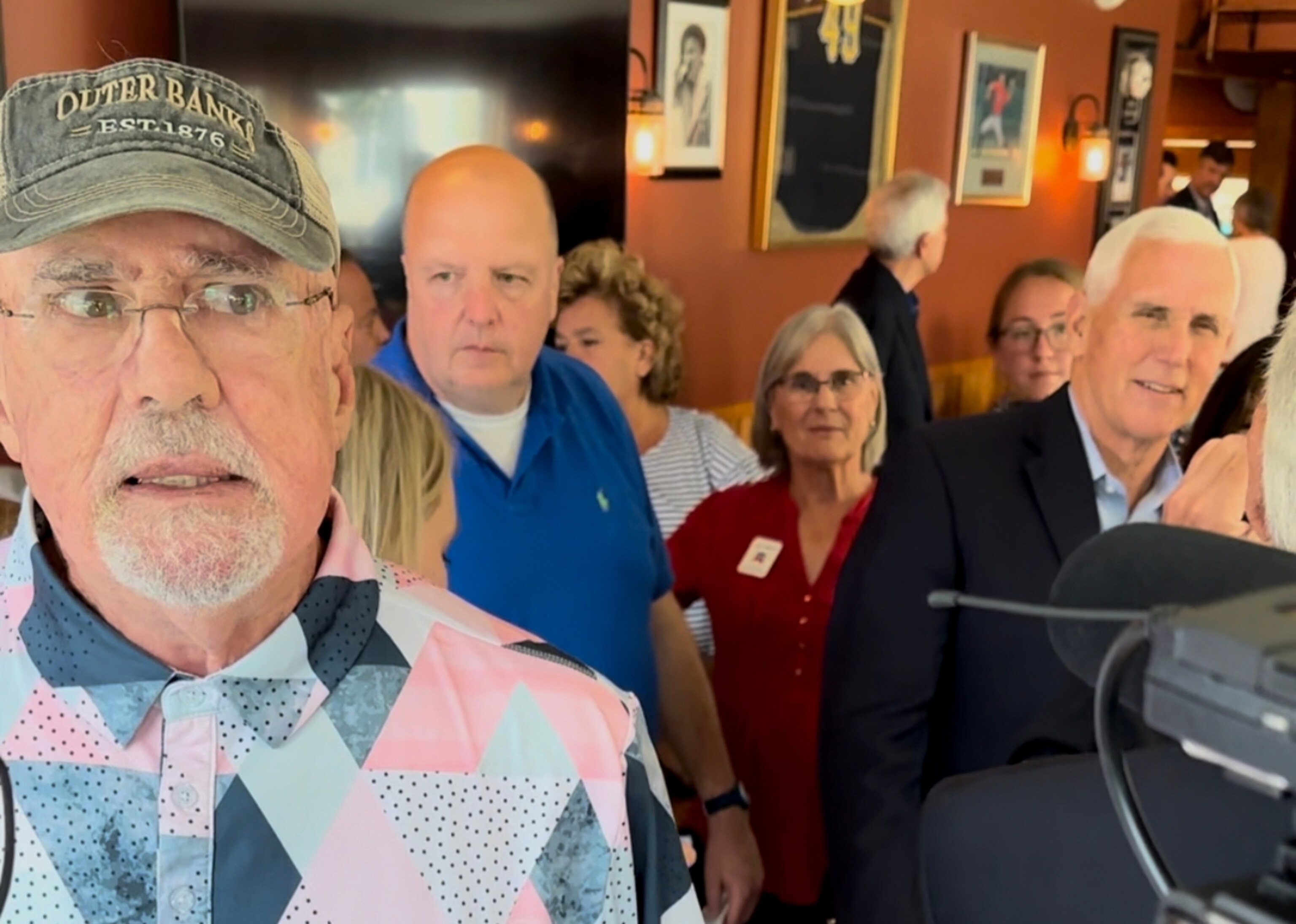 PHOTO: Tom Loughlin, 77, a registered Independent from Port St. Lucie, Florida, speaks to reporters at a meet and greet for former Vice President Mike Pence in North Conway, New Hampshire, on July 21, 2021.