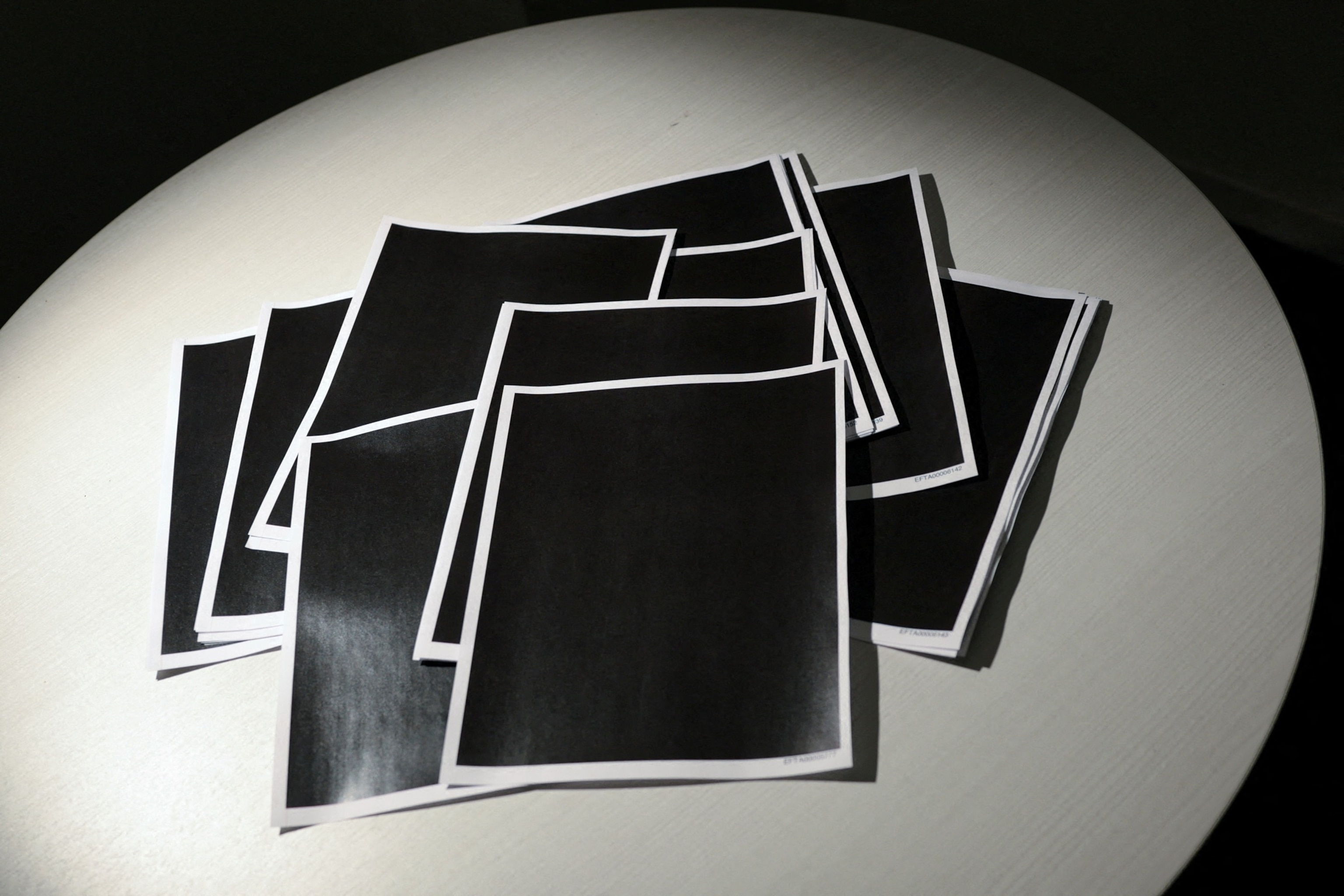 PHOTO: Newly released documents from the late financier and sex offender Jeffrey Epstein, including a sheaf of completely redacted pages, are seen in a Reuters photograph in Washington, DC, December 19, 2025.