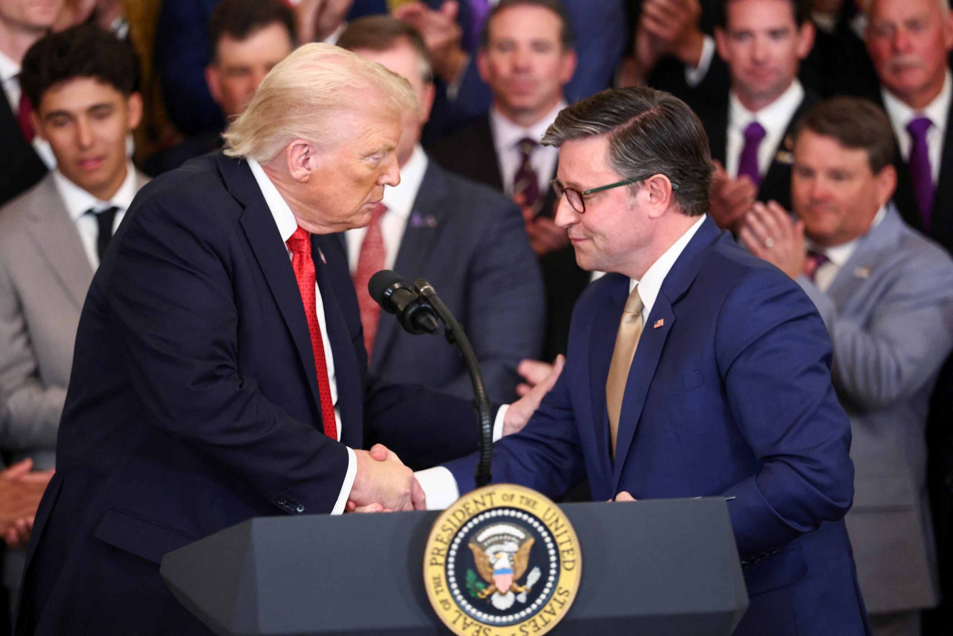 PHOTO: President Donald Trump and U.S. House Speaker Mike Johnson shake hands during an event honoring the LSU baseball NCAA national champions and the LSU-Shreveport baseball NAIA national champions at the White House, Oct. 20, 2025.  