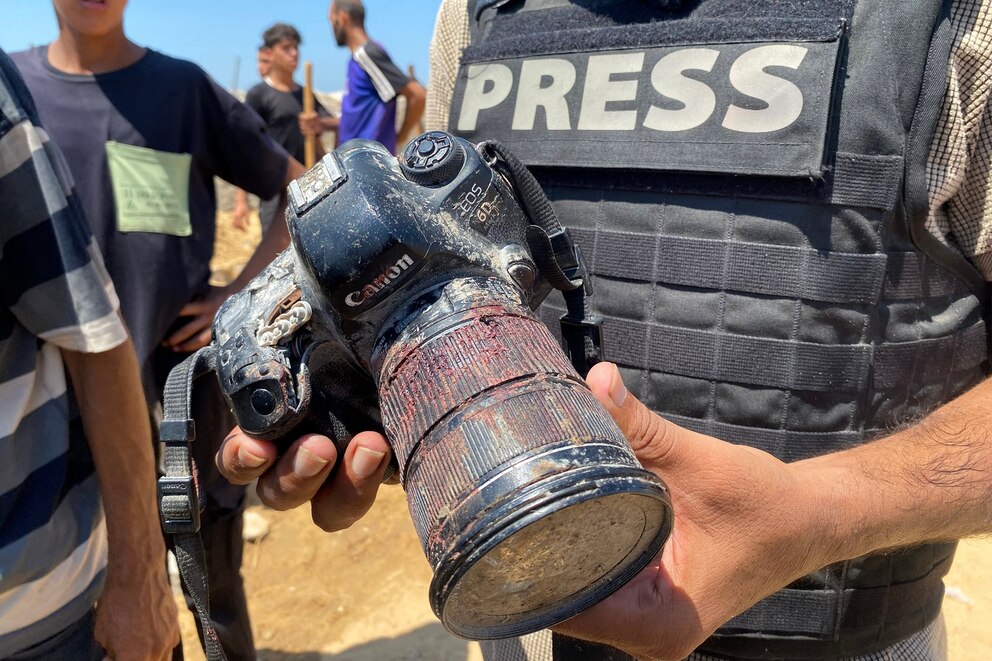 PHOTO: A journalist holds a camera belonging to Palestinian photojournalist Hussam al-Masri, a Reuters contractor who was killed in an Israeli strike on Nasser hospital in Khan Yunis in the southern Gaza Strip, during his funeral on Aug. 25, 2025.