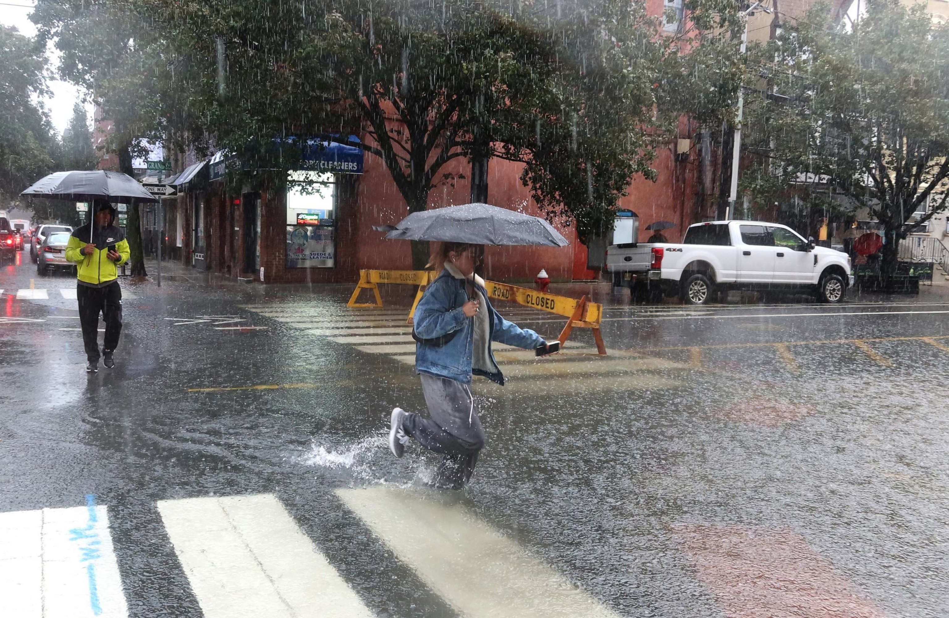 PHOTO: People walk through floodwaters in Hoboken, N.J., Sept. 29, 2023