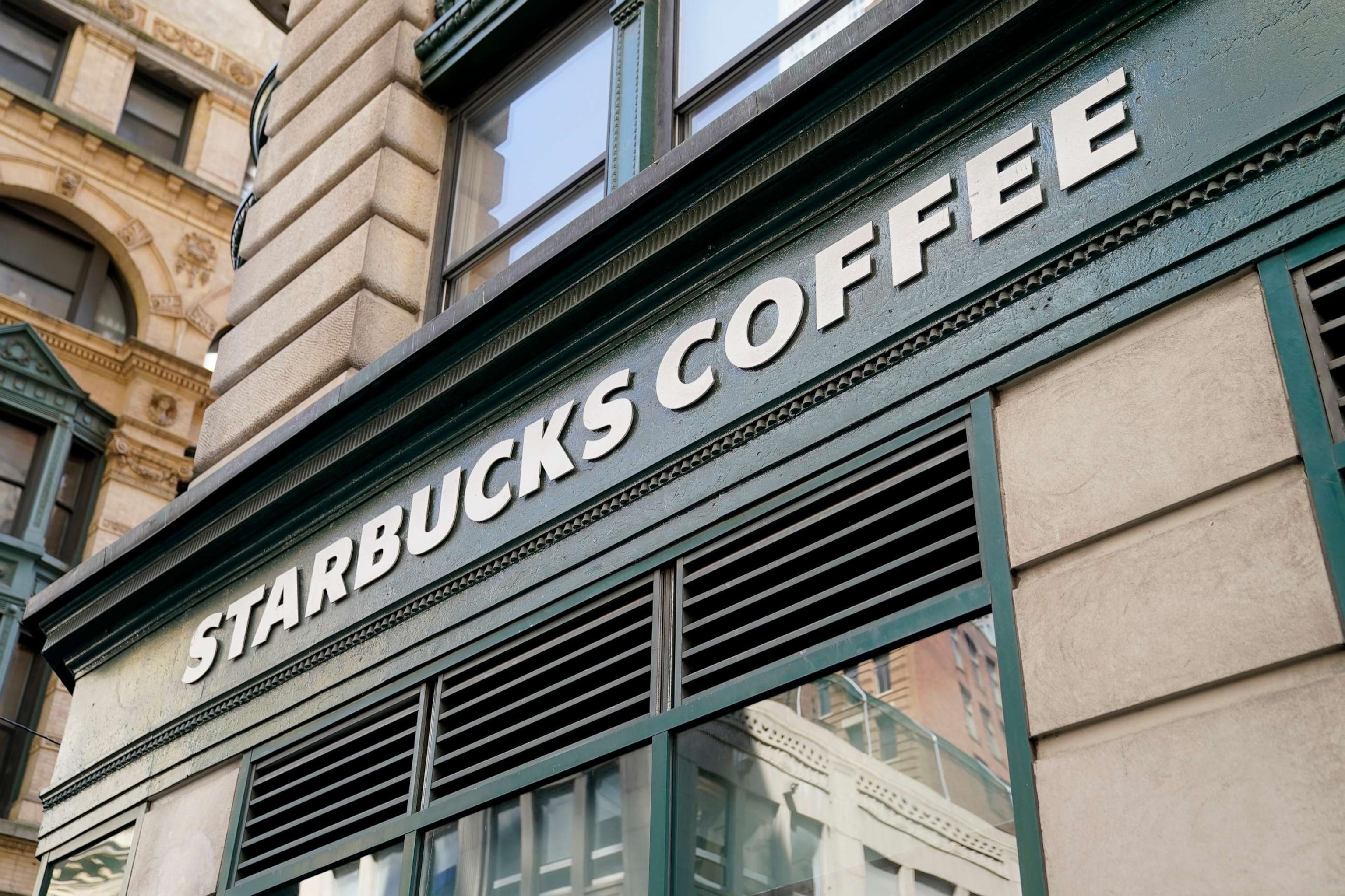 PHOTO: A Starbucks sign is displayed above a store in the Financial District of Lower Manhattan, June 13, 2023, in New York.