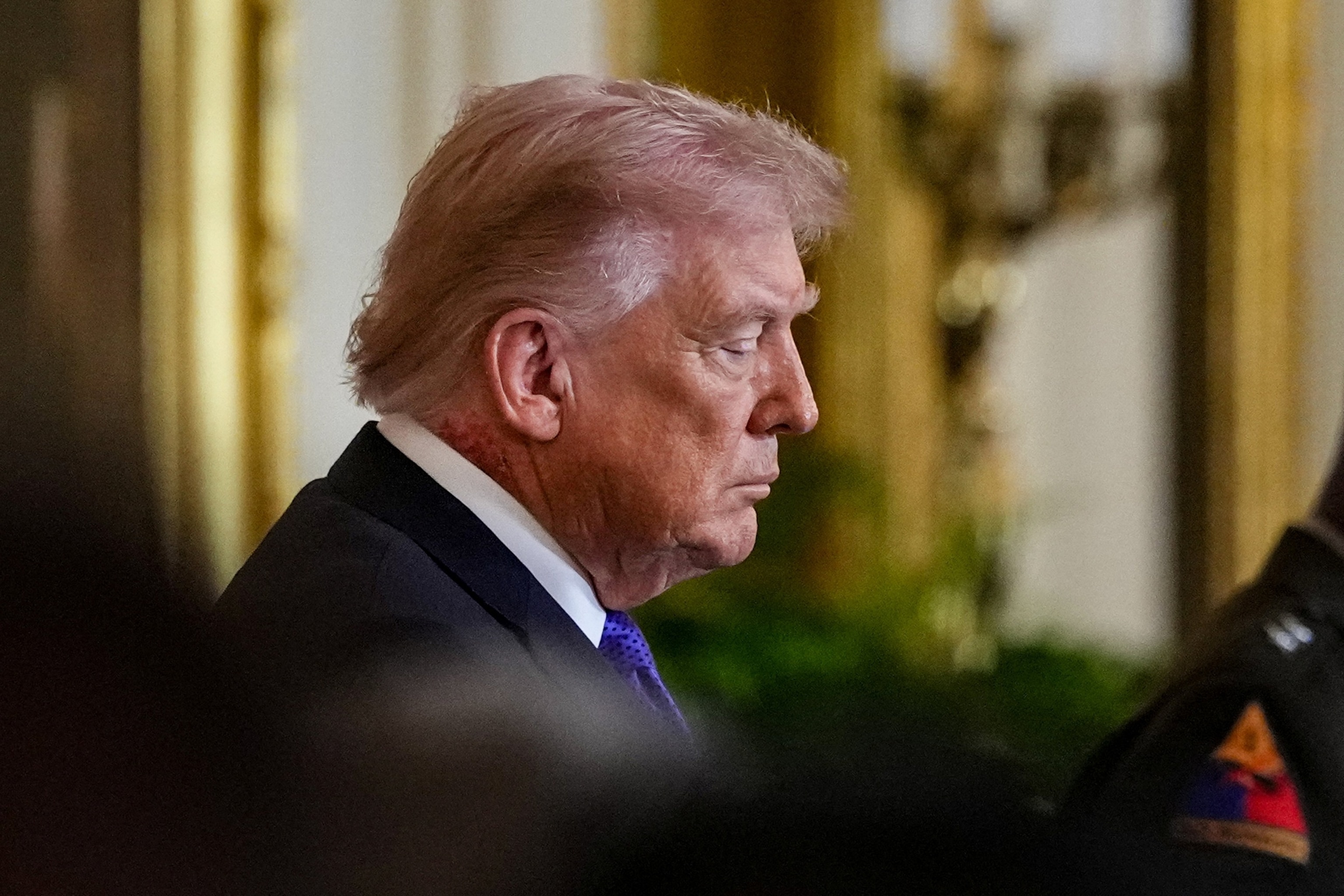 PHOTO: President Donald Trump looks on, as a patch of blemished skin is visible above his shirt collar, during a Medal of Honor ceremony at the White House in Washington, March 2, 2026.