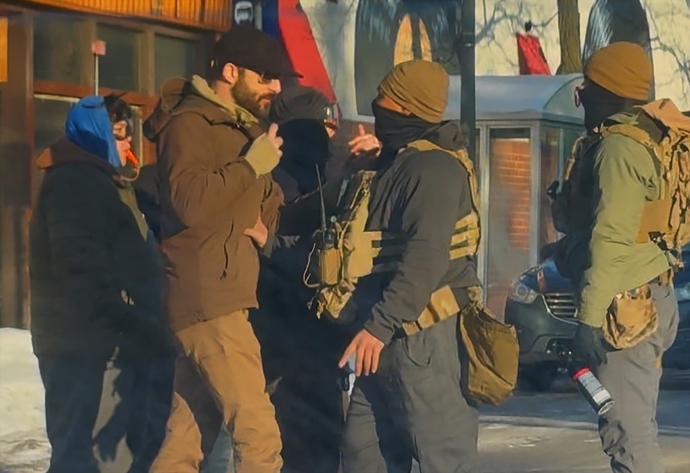 PHOTO: Three minutes and two seconds before the first shot is fired, Alex Pretti holds a phone before a federal officer on Nicollet Ave in Minnesota
