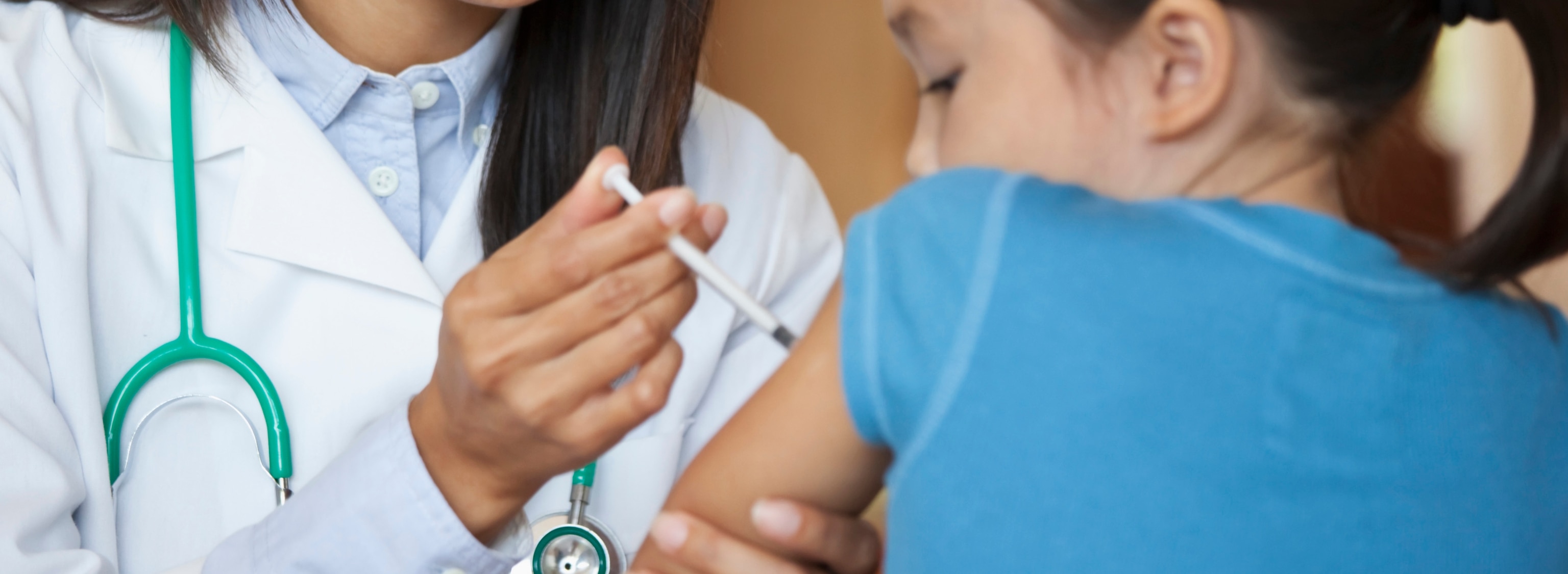 PHOTO: Doctor giving young girl injection in arm in an undated stock photo.