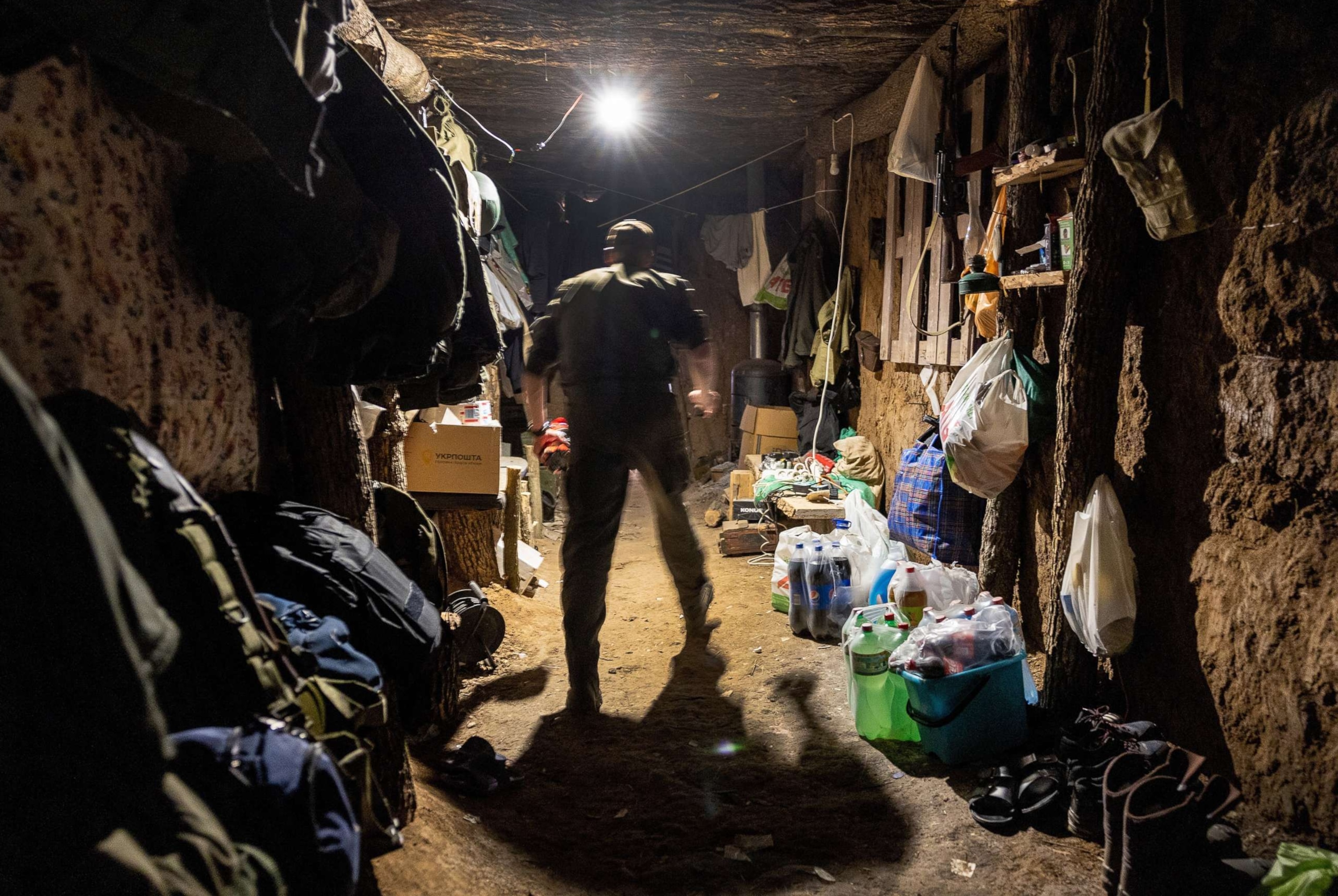 PHOTO: A Ukrainian national guard soldier walks through an underground bunker near a frontline position in Zelenodolsk, Ukraine, May 07, 2022.