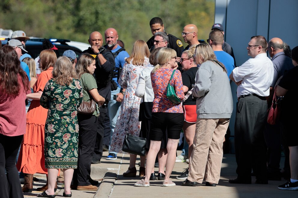 PHOTO: People gather near the scene of a shooting at a church in Grand Blanc, Michigan, on September 28, 2025