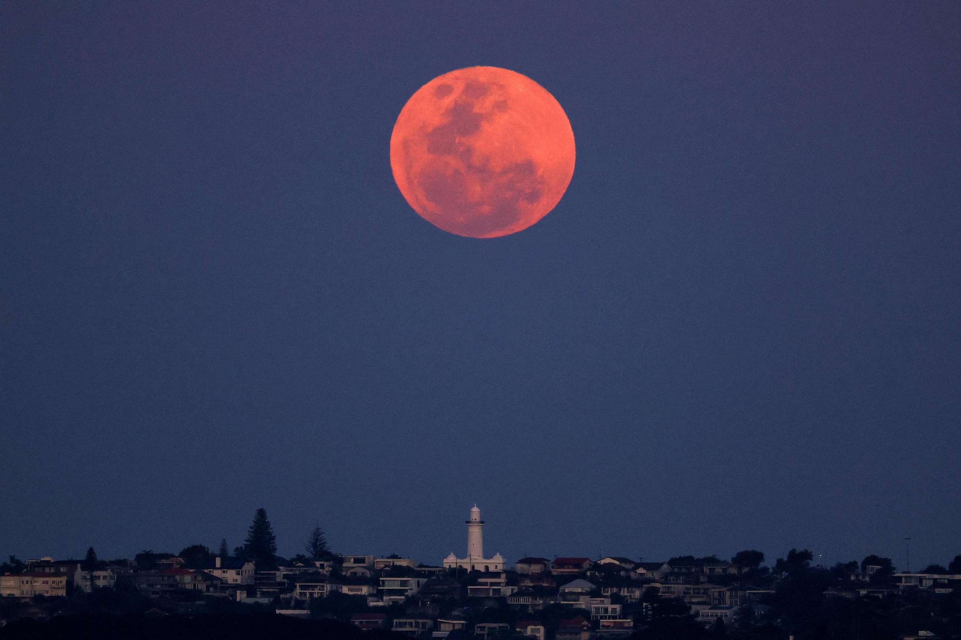 PHOTO: The full moon, a supermoon also known as the "Harvest Moon", rises over Macquarie Lighthouse in Sydney on Sept. 29, 2023.