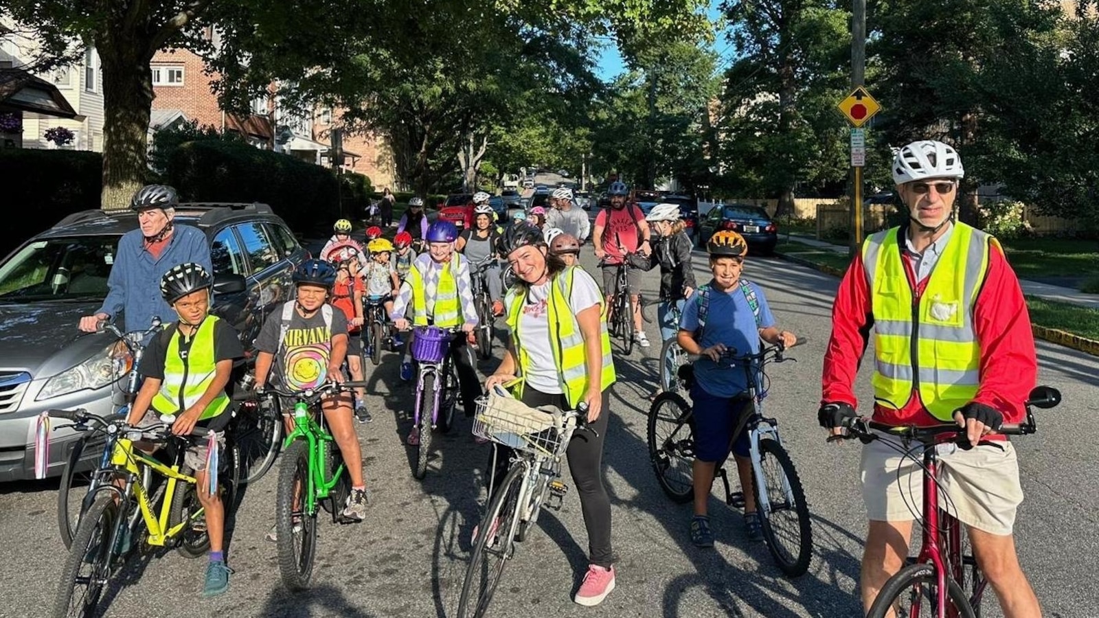 From a few to over 350, children and parents ride together to school as a 'bike bus'