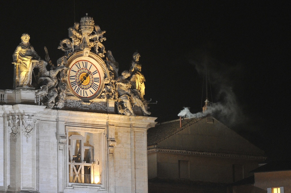 White smoke rises from the chimney on the roof of the Sistine Chapel meaning that cardinals elected a new pope during the conclave on  March 13, 2013 at the Vatican.