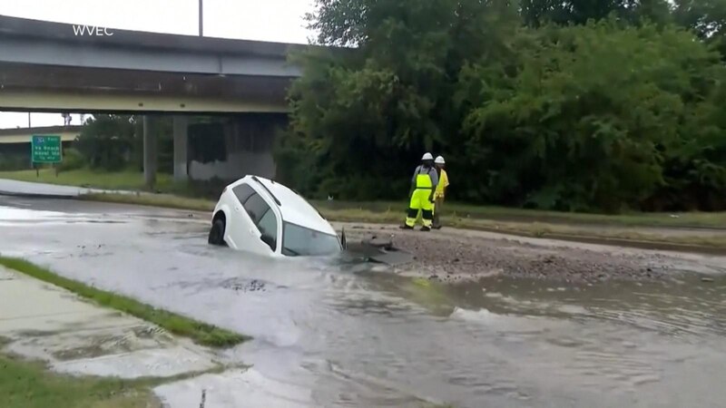 Police Officer Rescues Driver From Sinkhole