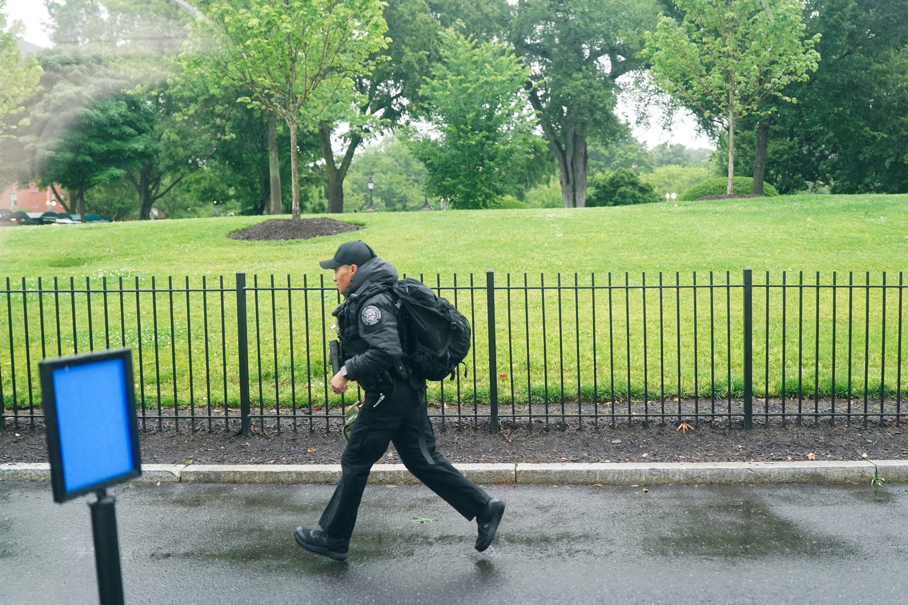 PHOTO: A U.S. Secret Service agent runs after alleged gunshots were heard nearby, at the White House in Washington