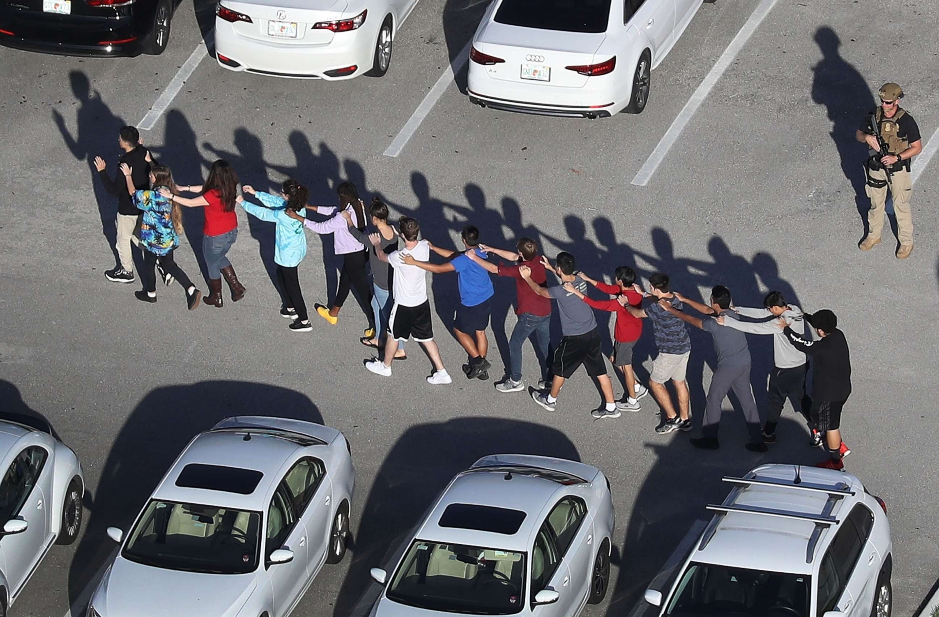 PHOTO: People are brought out of the Marjory Stoneman Douglas High School after a shooting at the school, Feb. 14, 2018 in Parkland, Fla.