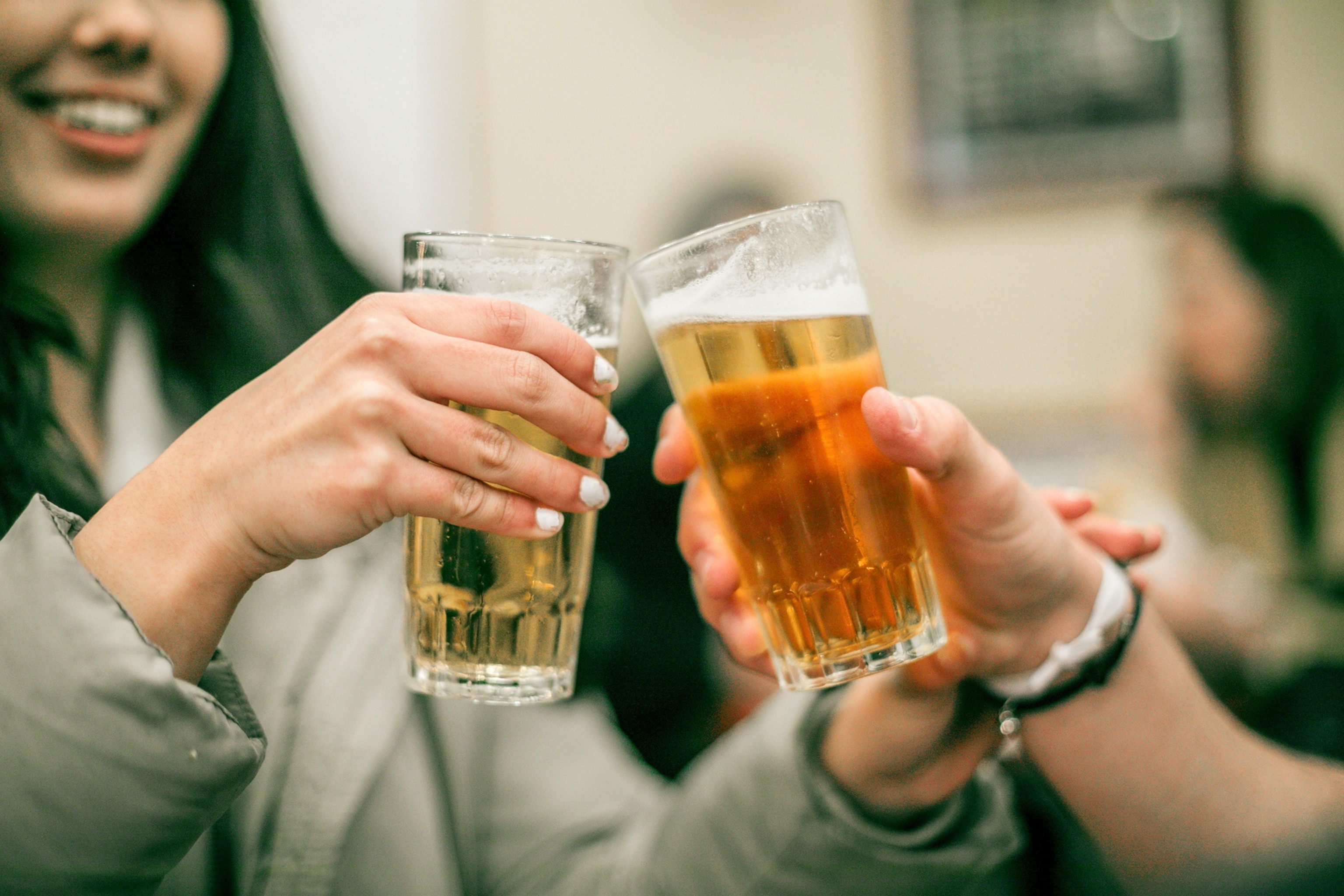 PHOTO: friends toasting beer glasses at table in bar