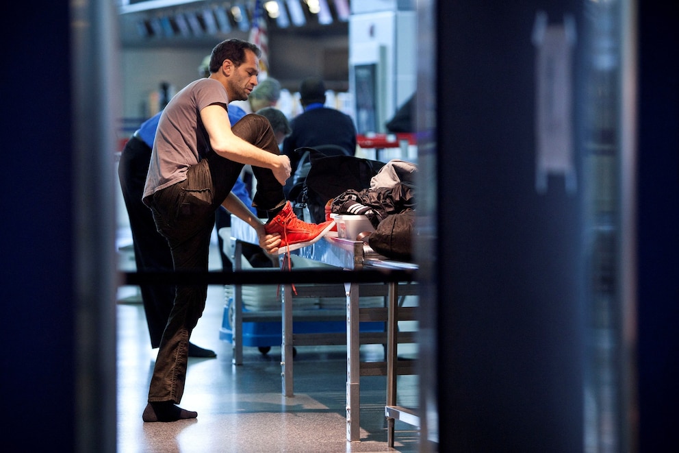 PHOTO: A traveler removes his shoes before going through a security check point at John F. Kennedy Airport in New York