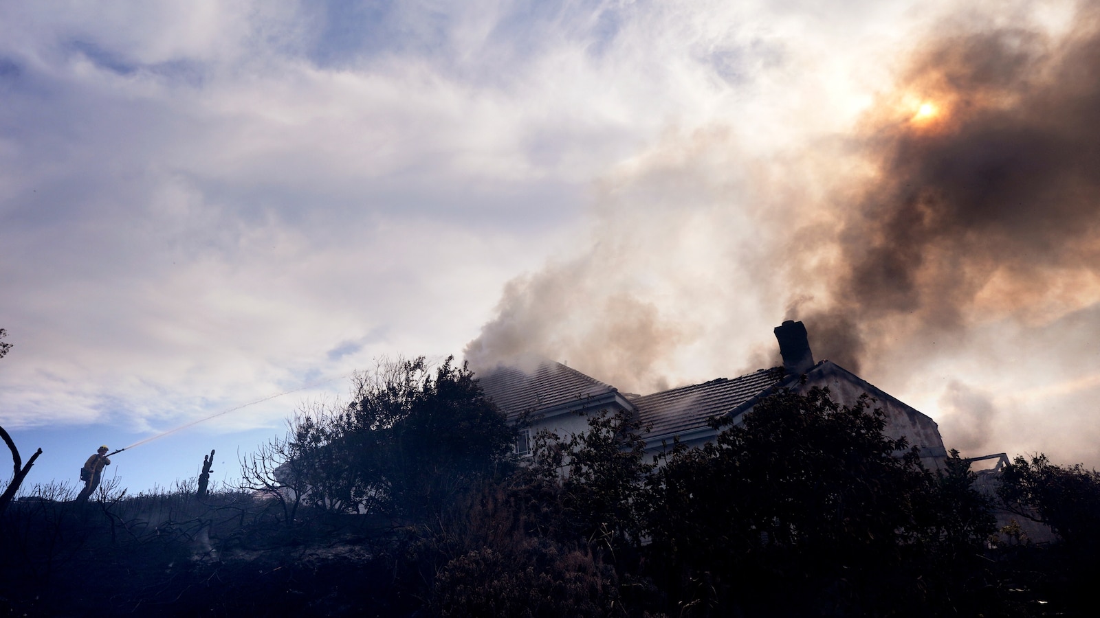 Fire crews battle Southern California blaze that burned 6 homes, led to the evacuation of 16,000