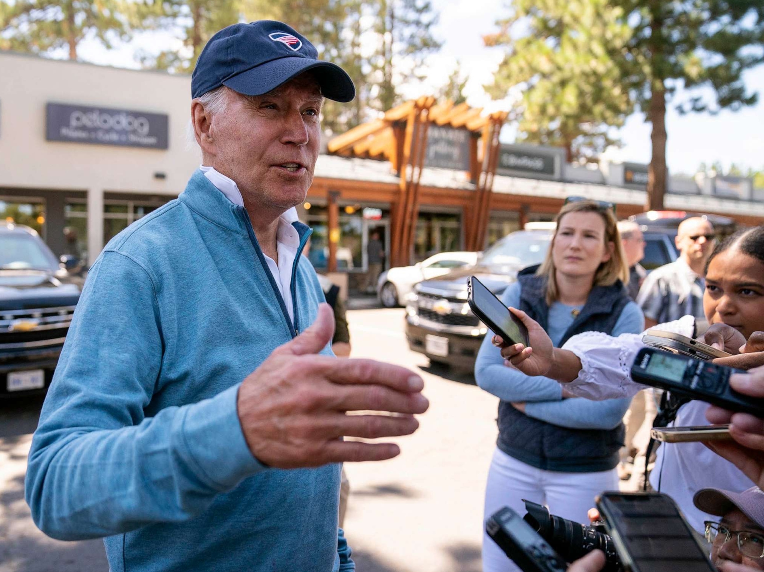 PHOTO: President Joe Biden talks with reporters after taking a Pilates and spin class at PeloDog, Aug. 25, 2023, in South Lake Tahoe, Calif.