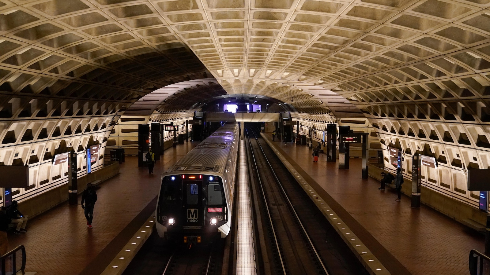 A work vehicle hits a stopped Washington Metro train, injuring 11