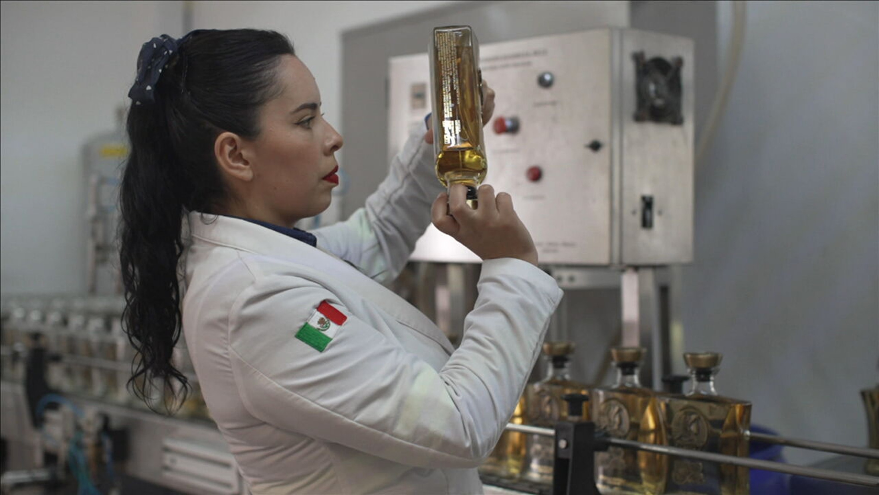 PHOTO: Sandra, a head chemist for the tequila distillery owned by Melly Bajaras, holds up a bottle of tequila in Jalisco, Mexico.