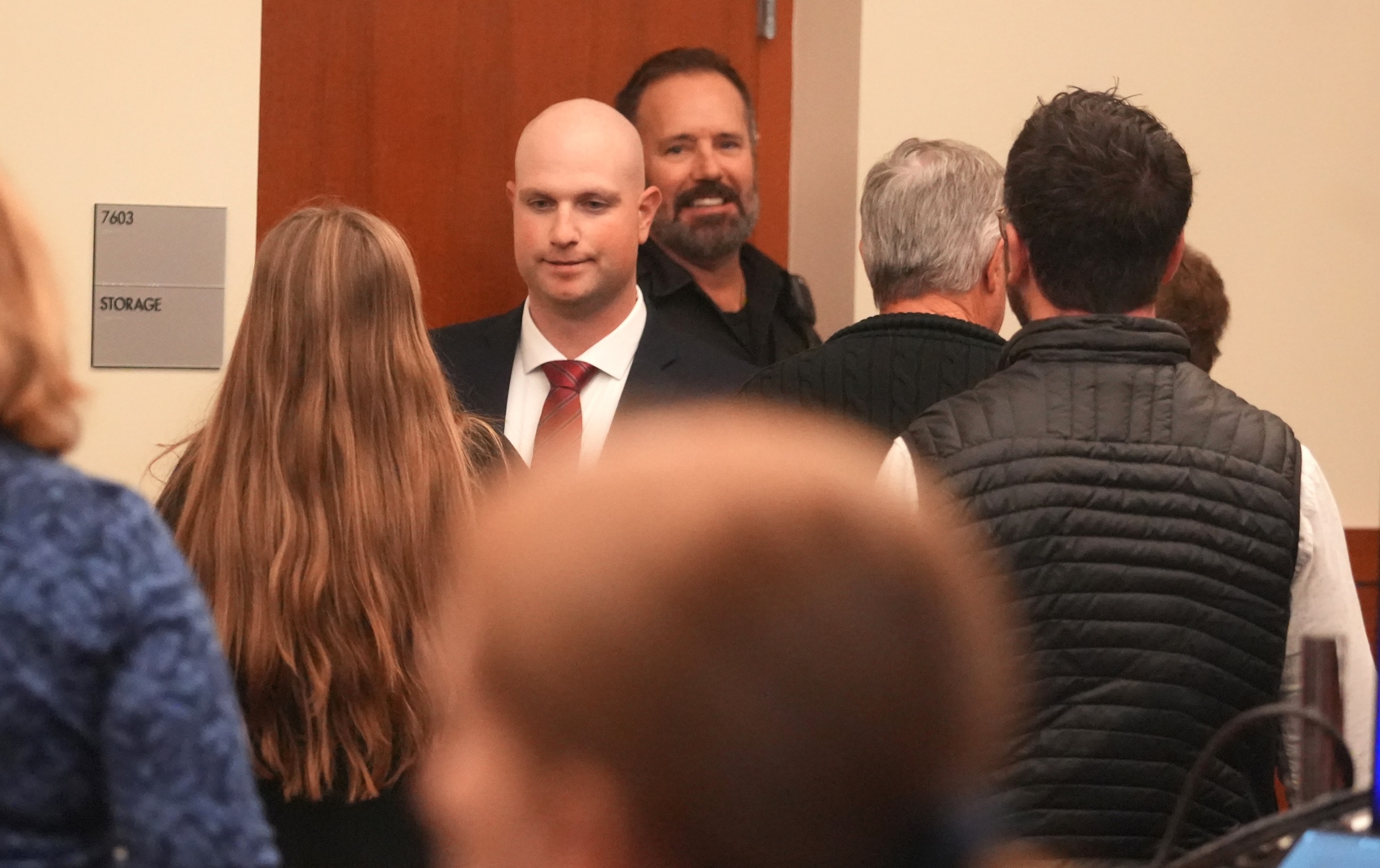 PHOTO: Blendon Township police officer Connor Grubb greets a family member after the not guilty verdict is read at Franklin County Common Pleas Court in Columbus, Ohio, on Nov. 21, 2025.