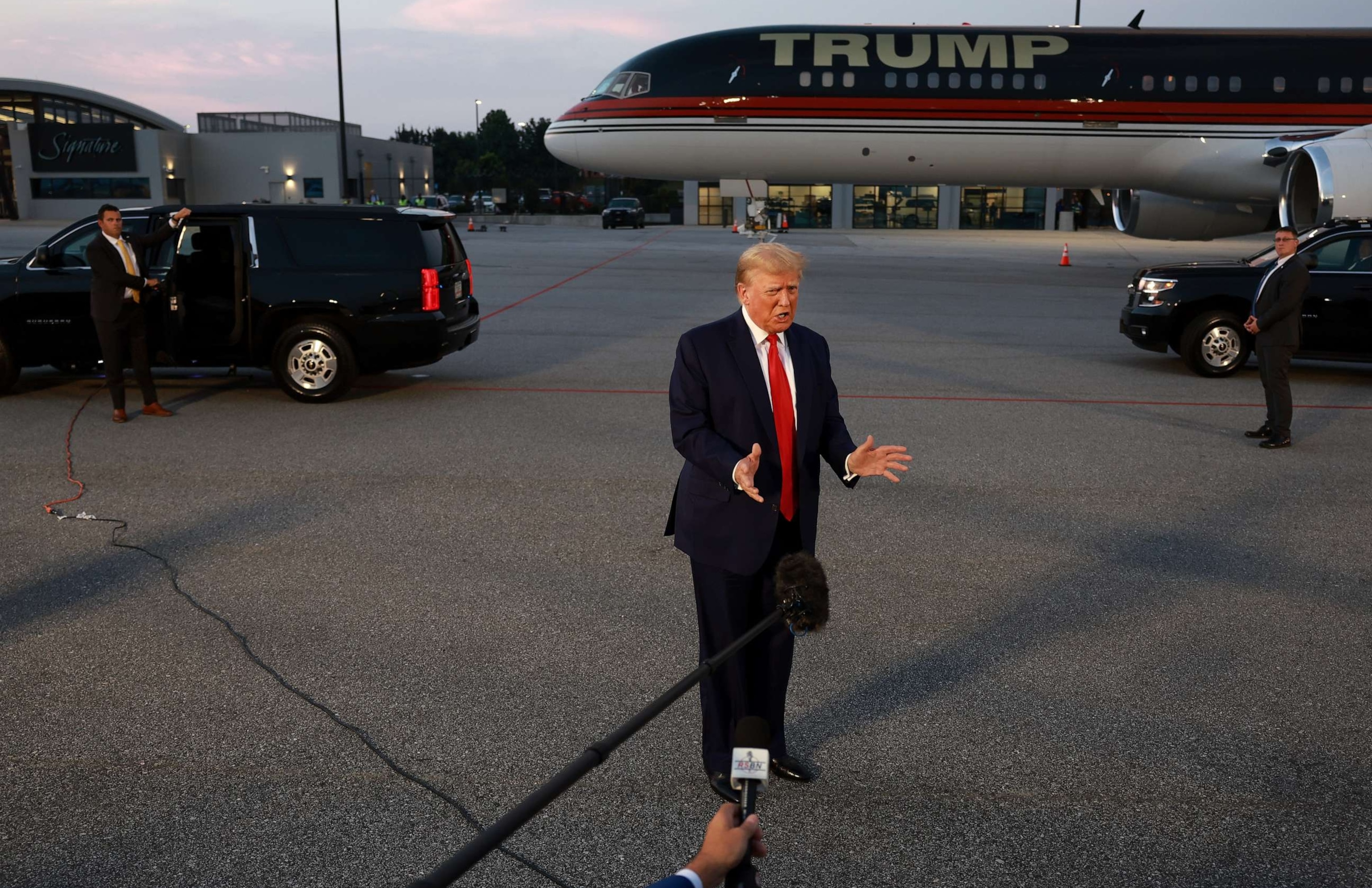 PHOTO: Former President Donald Trump speaks to the media at Atlanta Hartsfield-Jackson International Airport after surrendering at the Fulton County jail on Aug. 24, 2023 in Atlanta.