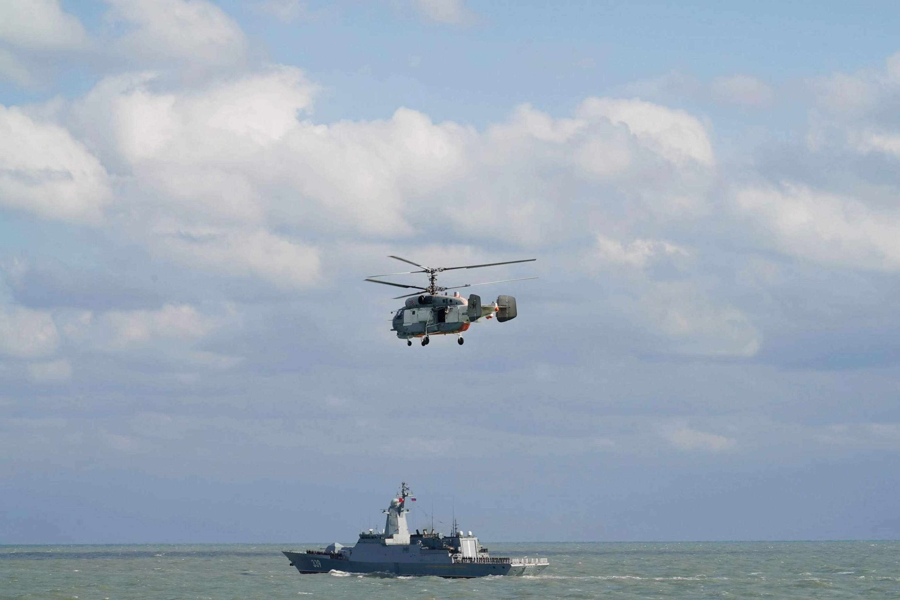 PHOTO: A warship and a helicopter from Russian navy are pictured after a joint naval exercise, Joint Sea 2022, in the East China Sea on Dec. 27, 2022.