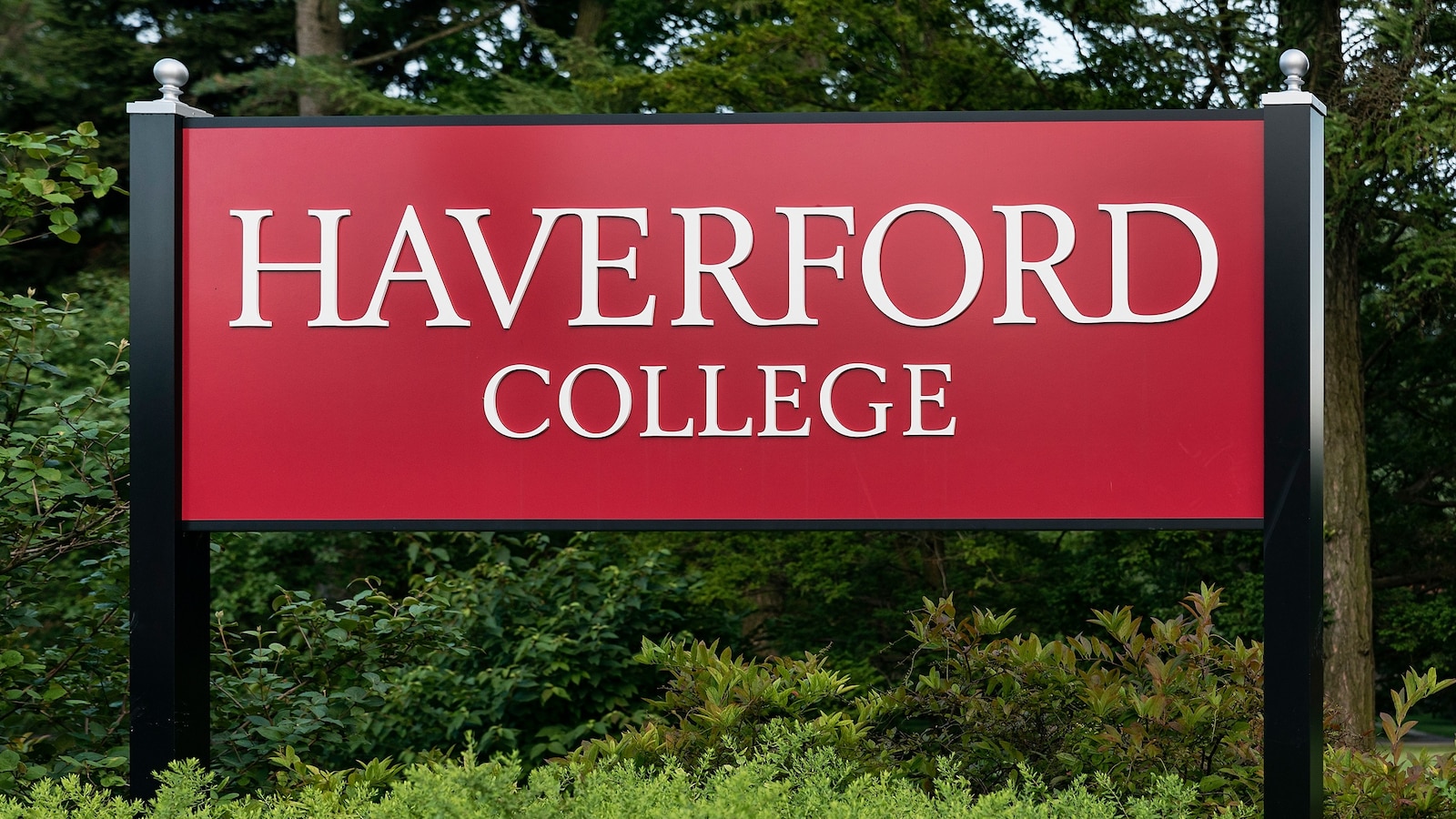 A Haverford College professor was arrested and charged with online harassment and intimidation, the school's president said in a statement Tuesday.