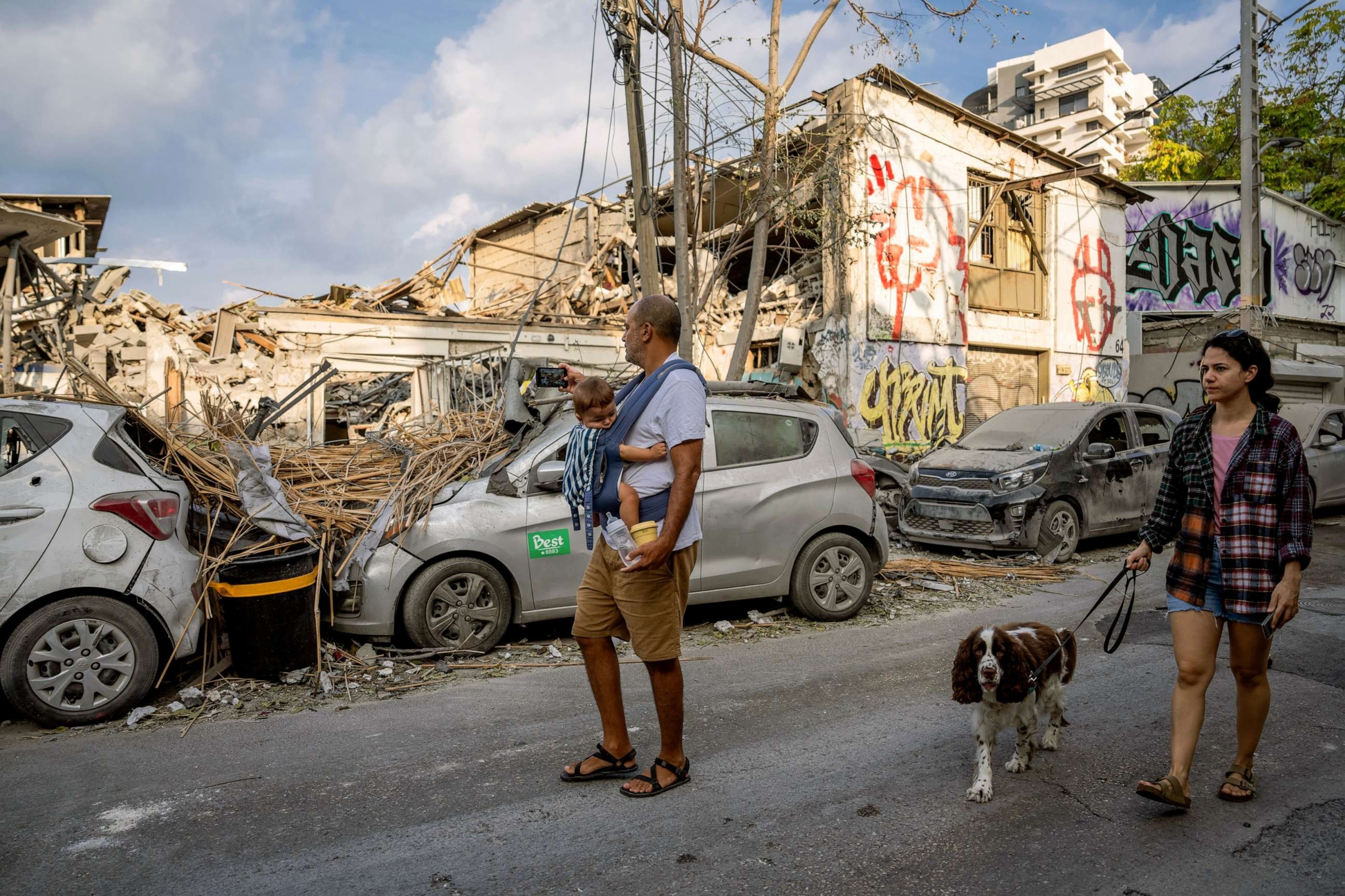 PHOTO: Israelis inspect the rubble of a building a day after it was hit by a rocket fired from the Gaza Strip, in Tel Aviv, Israel, Oct. 8, 2023.