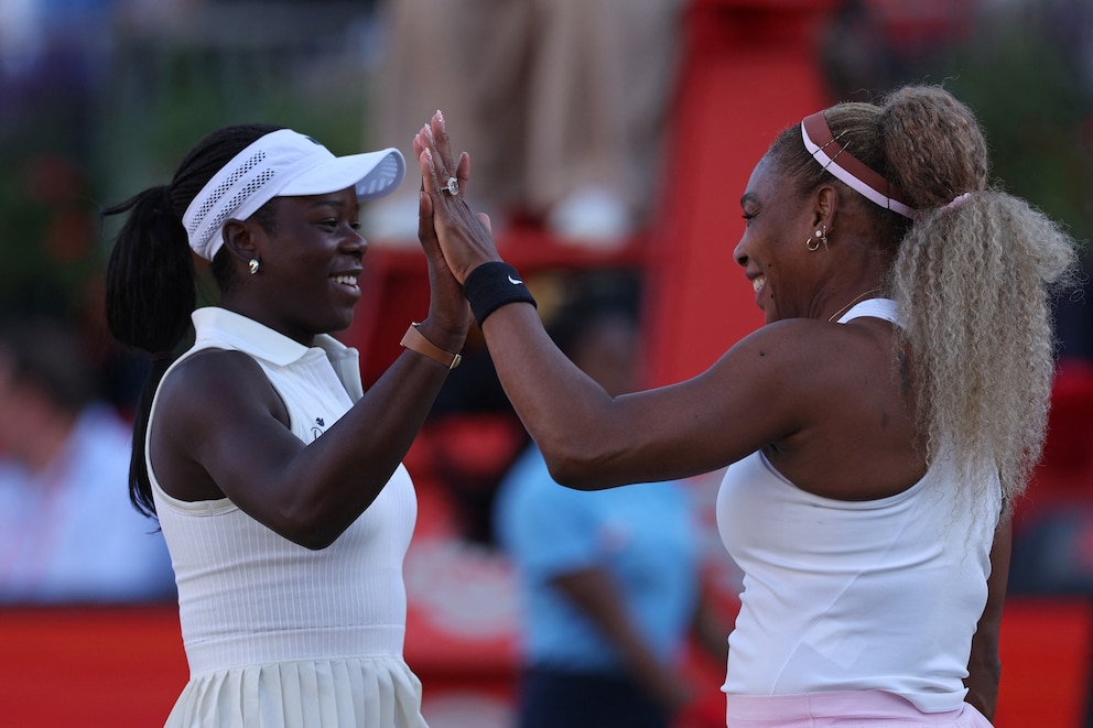 PHOTO: US player Serena Williams (R) and Canada's Victoria Mboko (L) celebrate while playing US player Nicole Melichar-Martinez and New Zealand's Erin Routliffe during their round of 16, doubles match at Queen's Club in west London on June 9, 2026. 