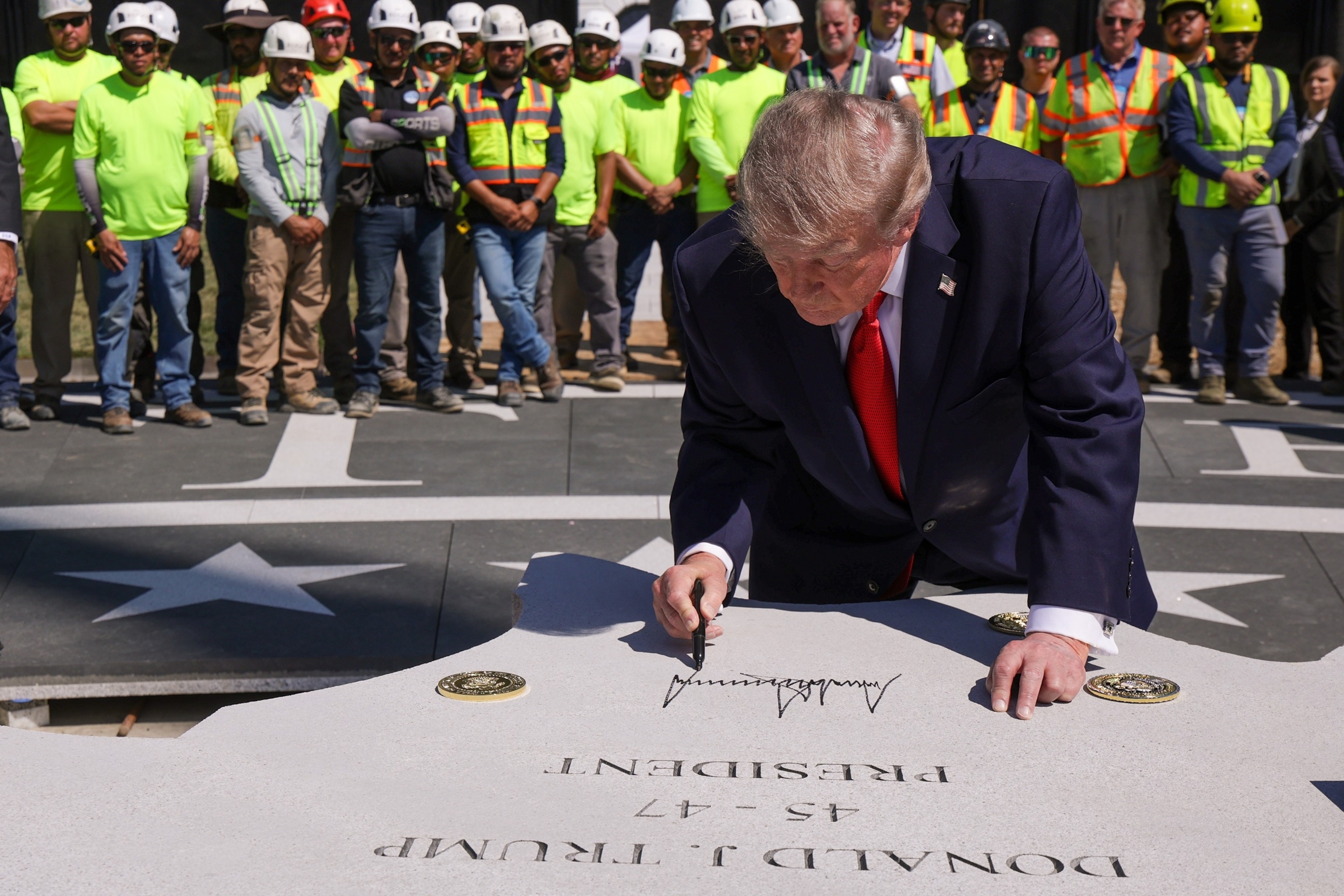 Trump unveils new granite helipad at the White House amid construction activity