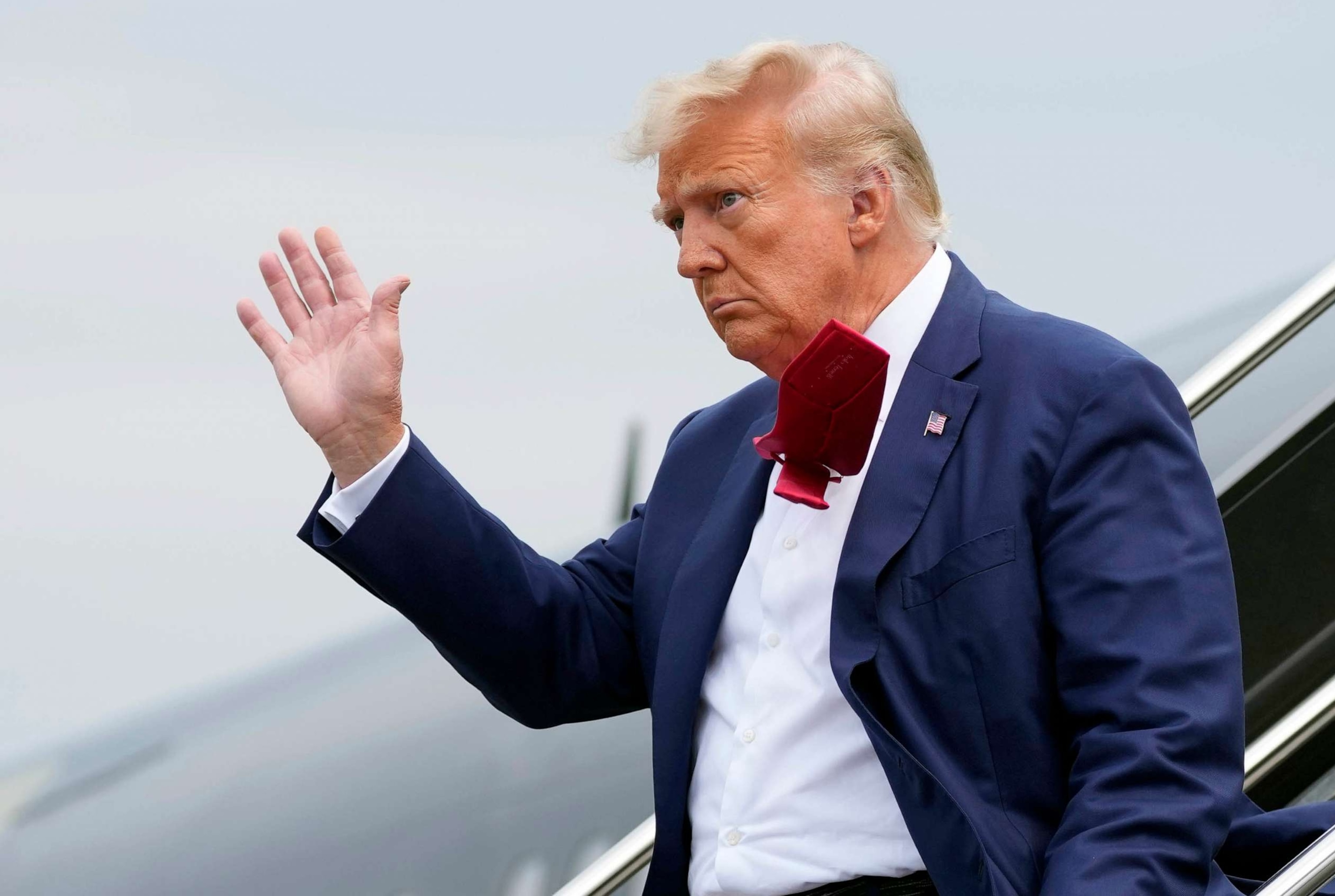 PHOTO: FILE - Former President Donald Trump waves as he steps off his plane at Ronald Reagan Washington National Airport, Aug. 3, 2023, in Arlington, Va.