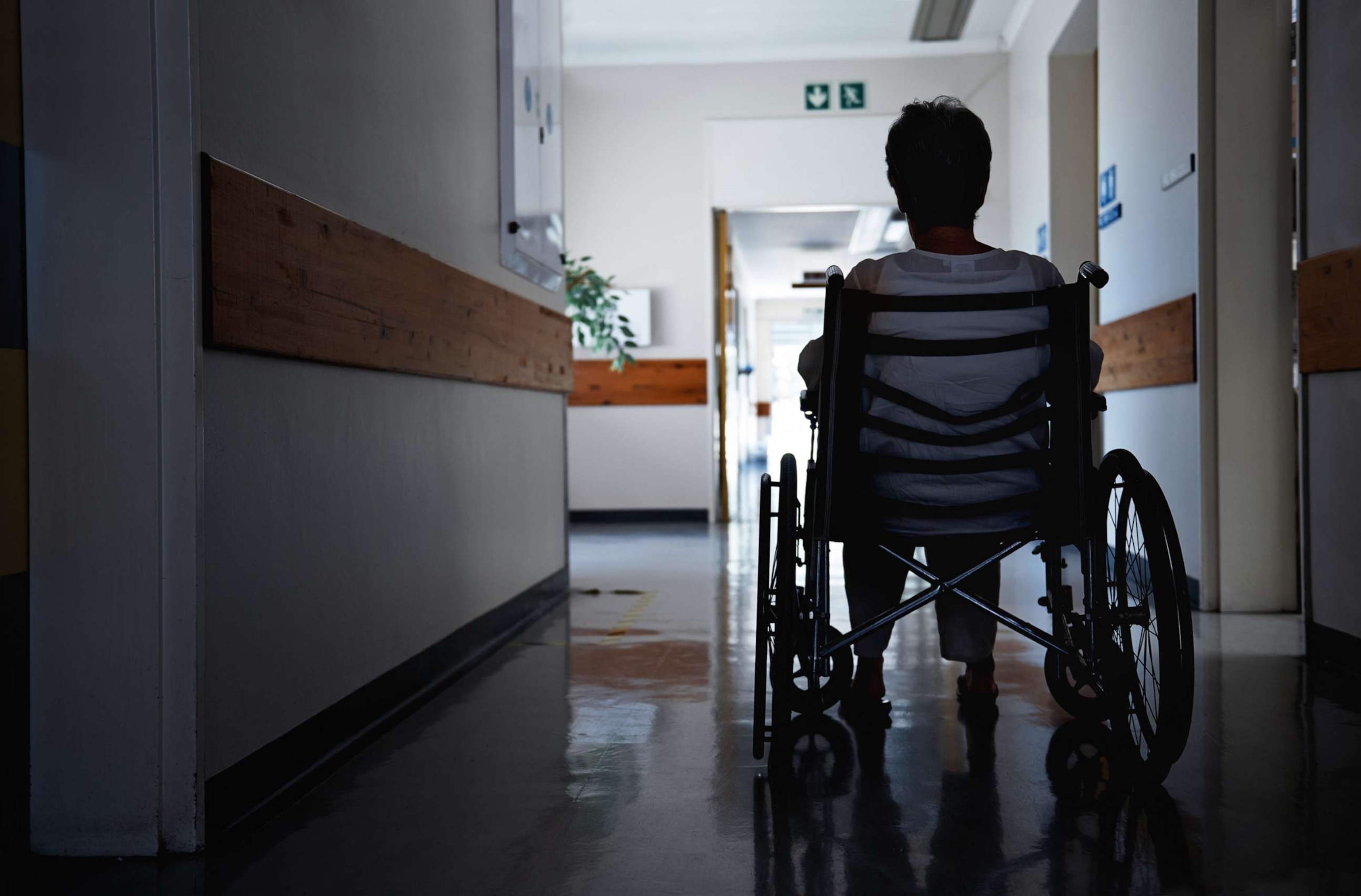 PHOTO: Rearview shot of a senior woman sitting in a wheelchair