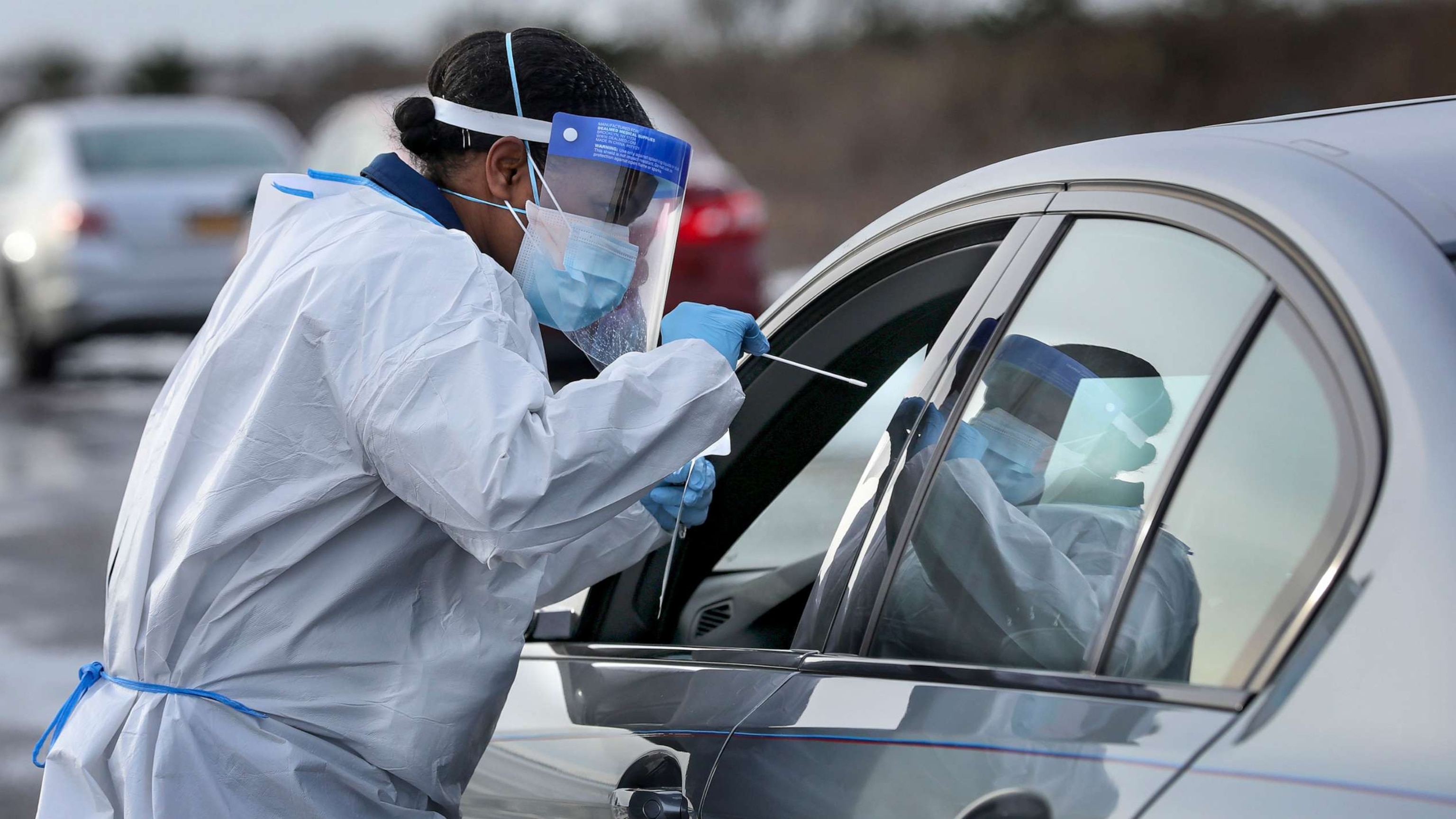 PHOTO: Nurse practitioner Deborah Beauplan administers a COVID-19 swab test at a drive-thru testing site at Smith Point Park, Dec. 19, 2020, in Shirley, N.Y.