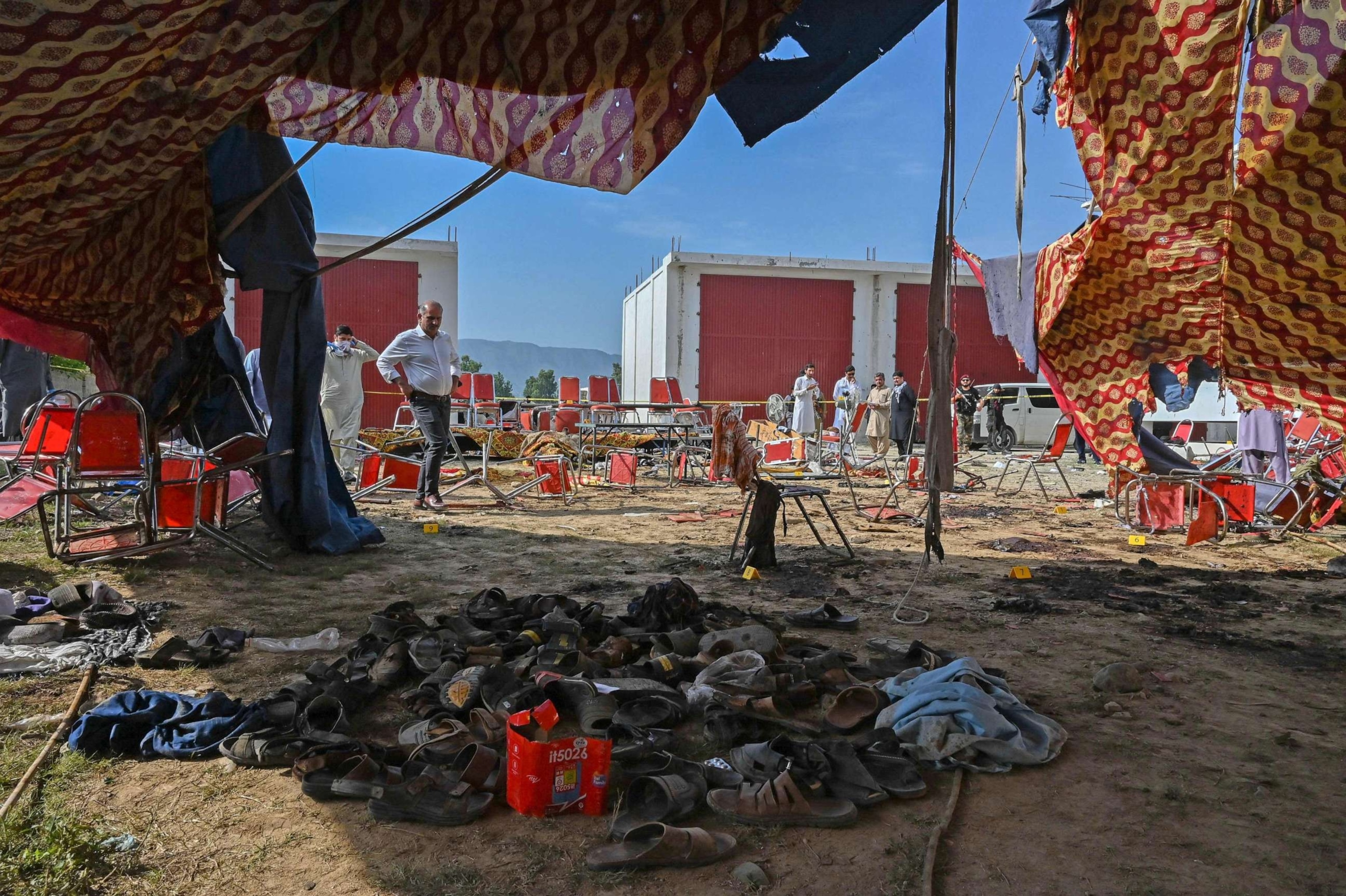 PHOTO: Police officials examine the site of a bomb blast in Bajaur district of Khyber-Pakhtunkhwa province on July 31, 2023.