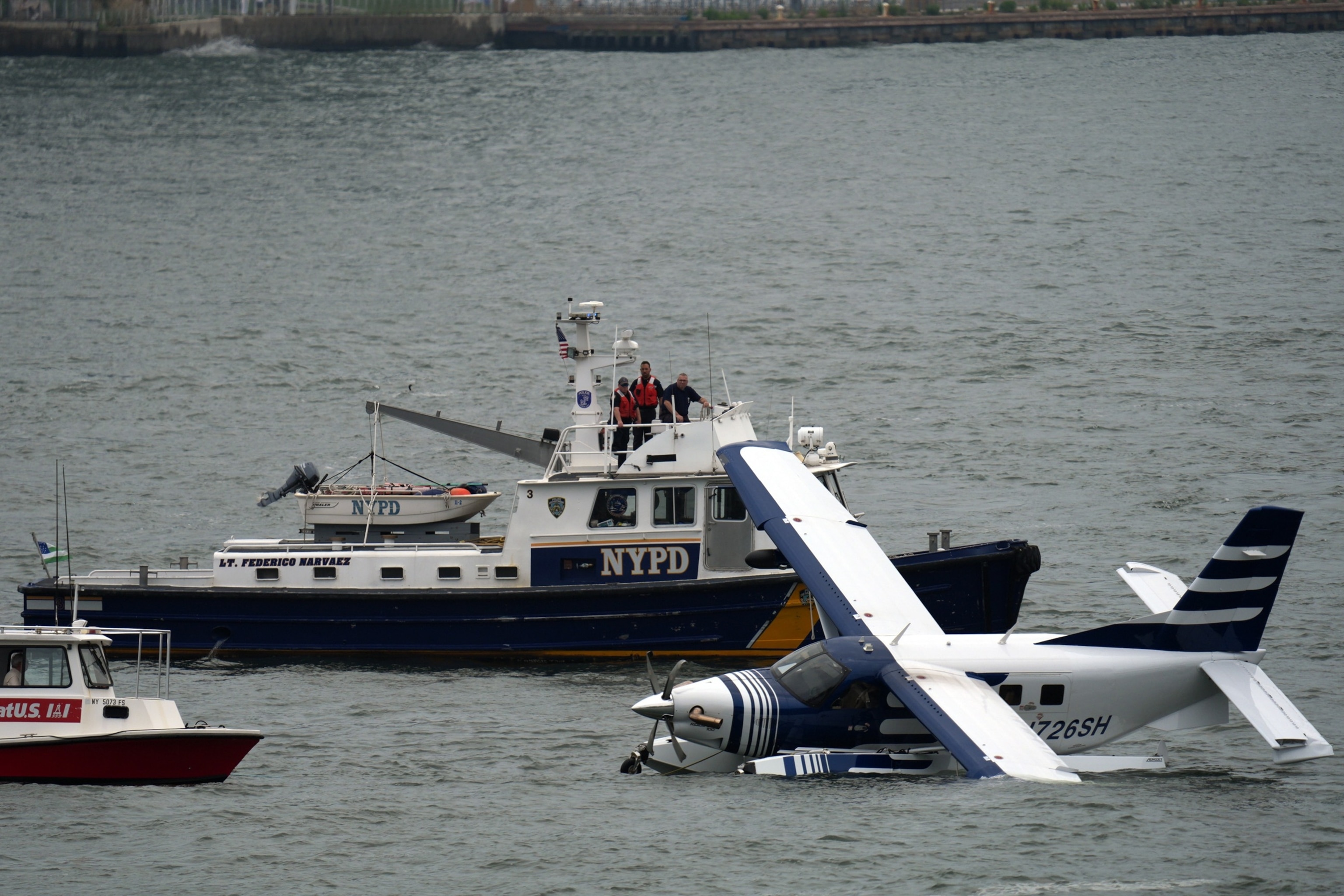 Emergency services respond to a crashed seaplane in the East River on July 5, 2026, in New York City. 