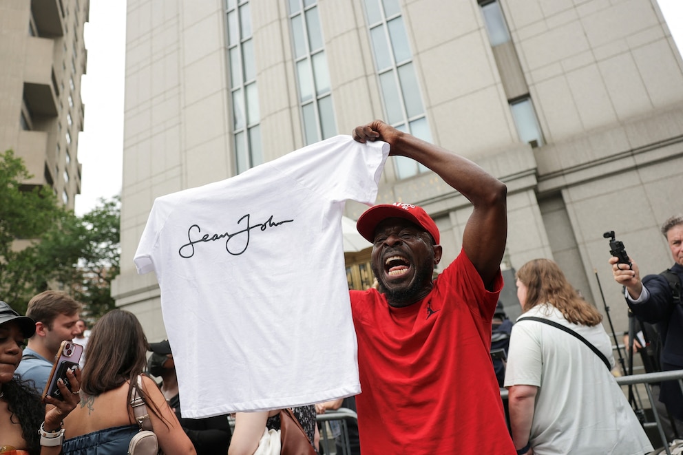 PHOTO: A man holding a Sean John T-shirt reacts outside the U.S. federal court, after the jury reached verdicts in the Sean "Diddy" Combs sex trafficking and racketeering conspiracy trial, in New York City, July 2, 2025.