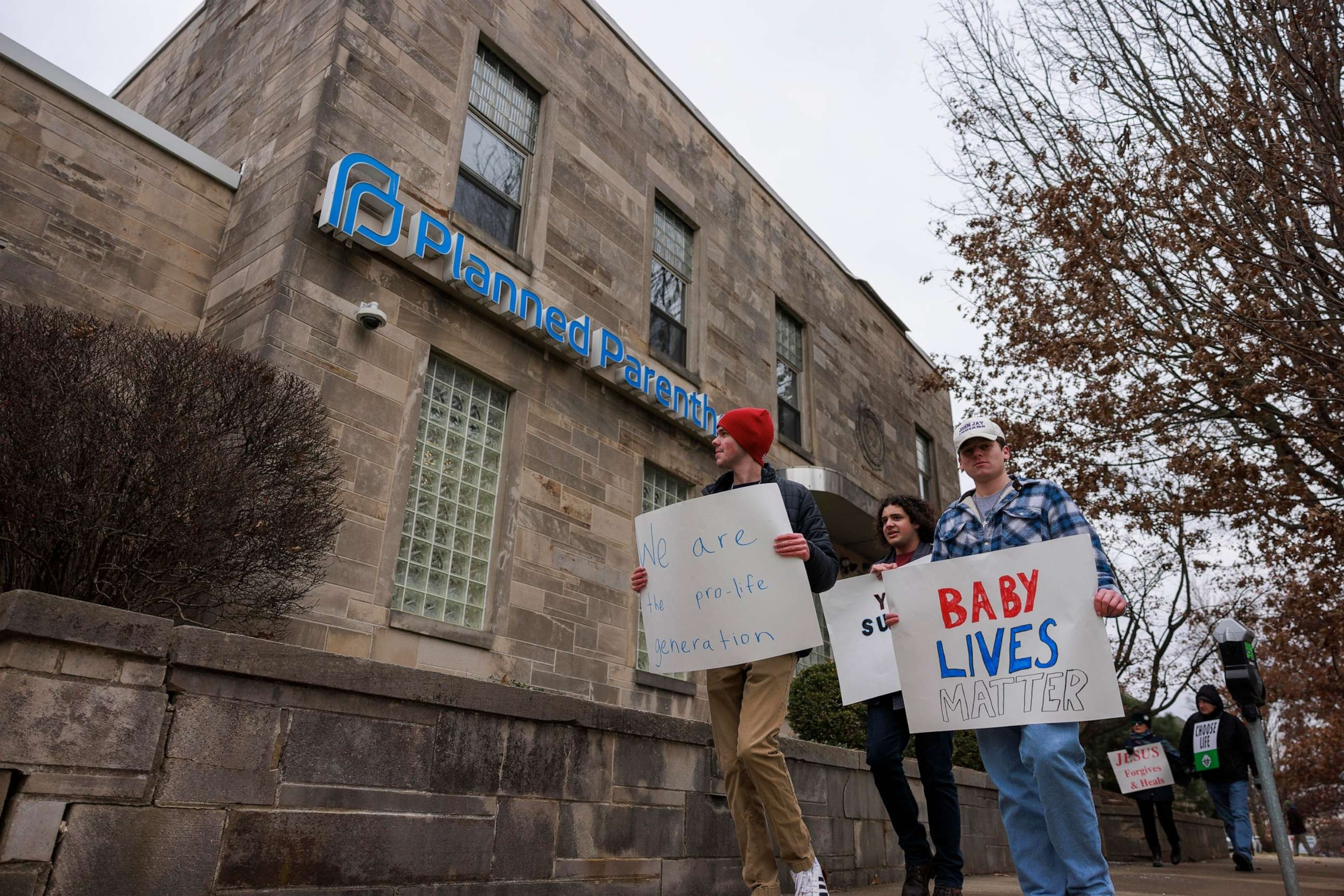 PHOTO: In this Jan. 23, 2021, file photo, anti-abortion protesters march past Planned Parenthood while holding signs during the Rally for Life in Bloomington, Indiana.