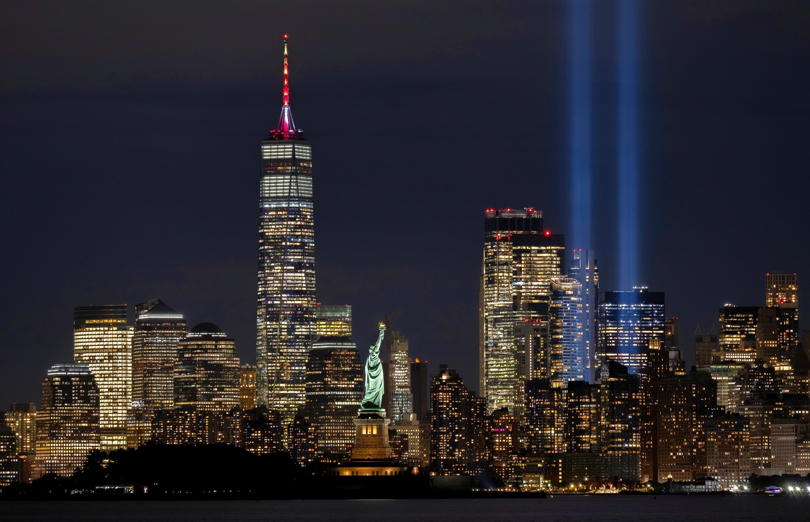 PHOTO: The Tribute in Light is illuminated above the skyline of lower Manhattan and One World Trade Center behind the Statue of Liberty ahead of the 24th anniversary of the 9/11 attacks in New York City, September 10, 2025.