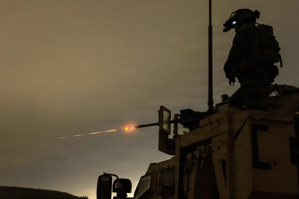 PHOTO: A machine gunner with Weapons Company, Battalion Landing Team 3/6, 22nd Marine Expeditionary Unit engages a target with an M2A1 .50-caliber machine gun during a night range on Camp Santiago, Puerto Rico, Oct. 21, 2025.