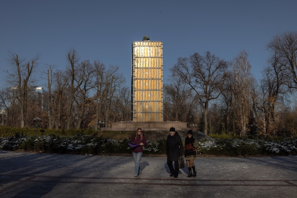 PHOTO: Pedestrians walk past the statue of Ukrainian poet Taras Shevchenko, covered to protect it from shelling,  in a park in Kyiv, Ukraine, on Nov. 26, 2024.