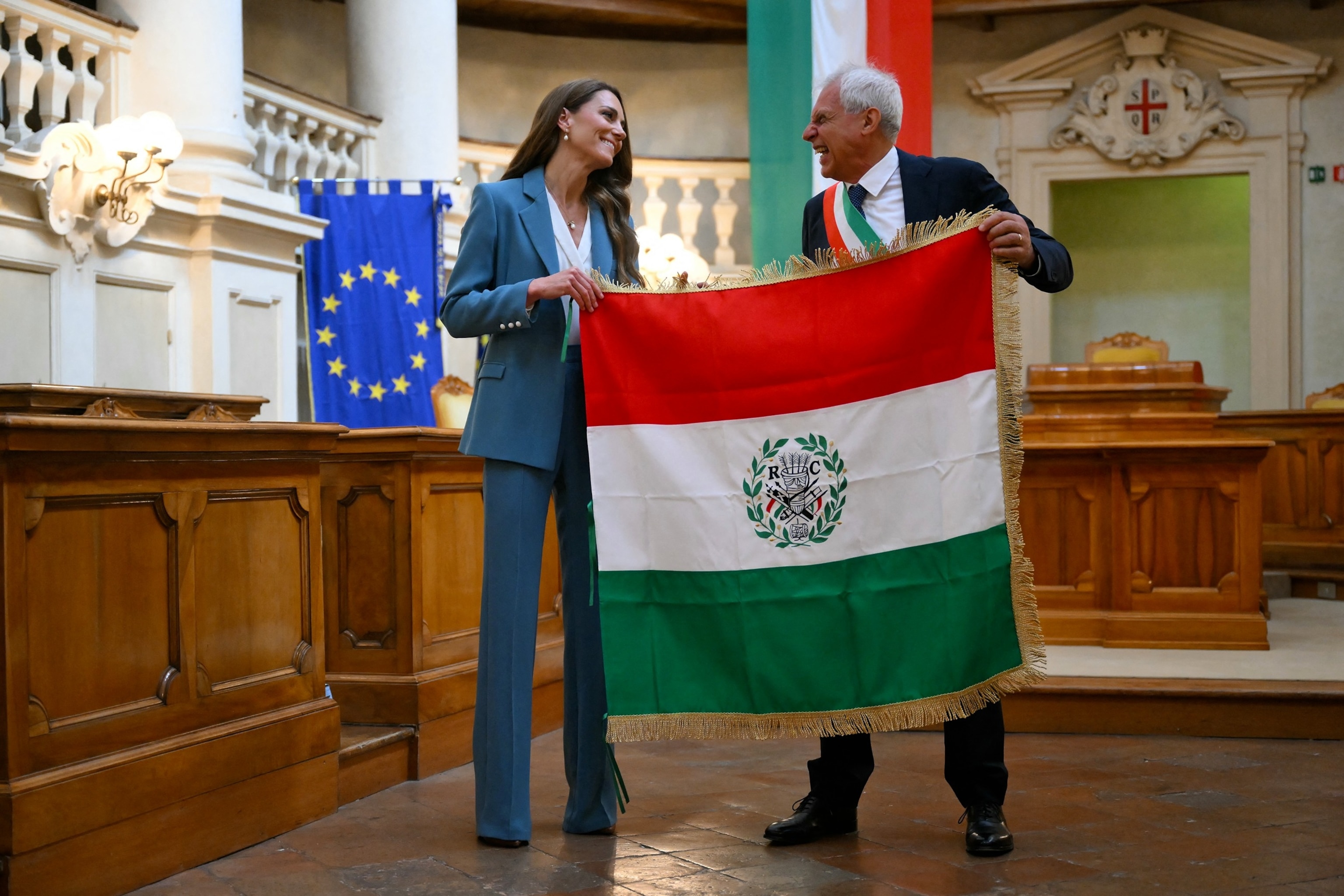 PHOTO: Britain's Catherine, Princess of Wales is presented with the 'Primo Tricolore', the city's highest honor, in recognition of her early years work by the mayor of Reggio Emilia, Marco Massari at Reggio Emilia's town hall in Italy, May 13, 2026. 