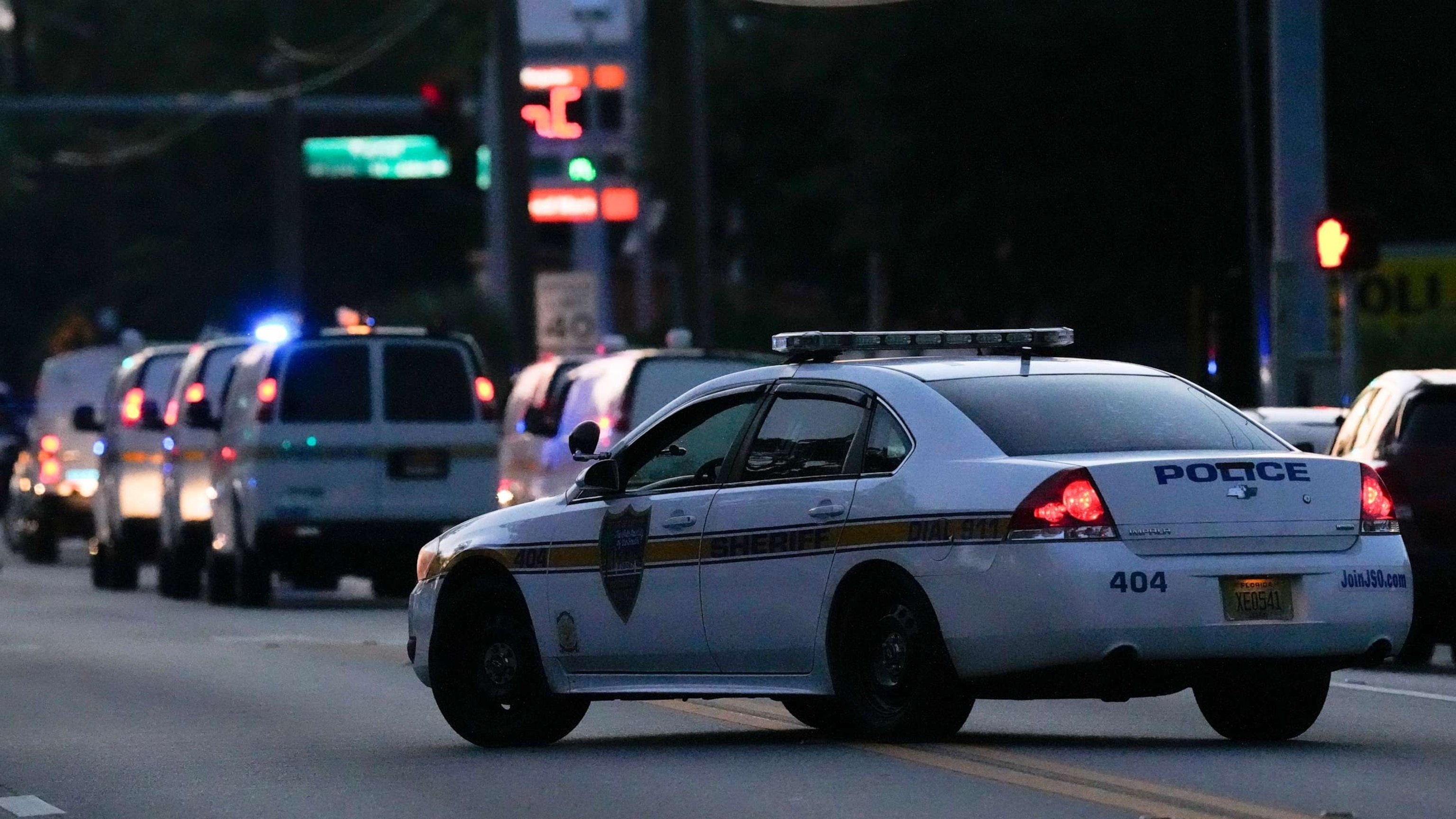 PHOTO: Law enforcement vehicles line the street as officials investigate the scene of a mass shooting at a Dollar General store Aug. 26, 2023, in Jacksonville, Fla.